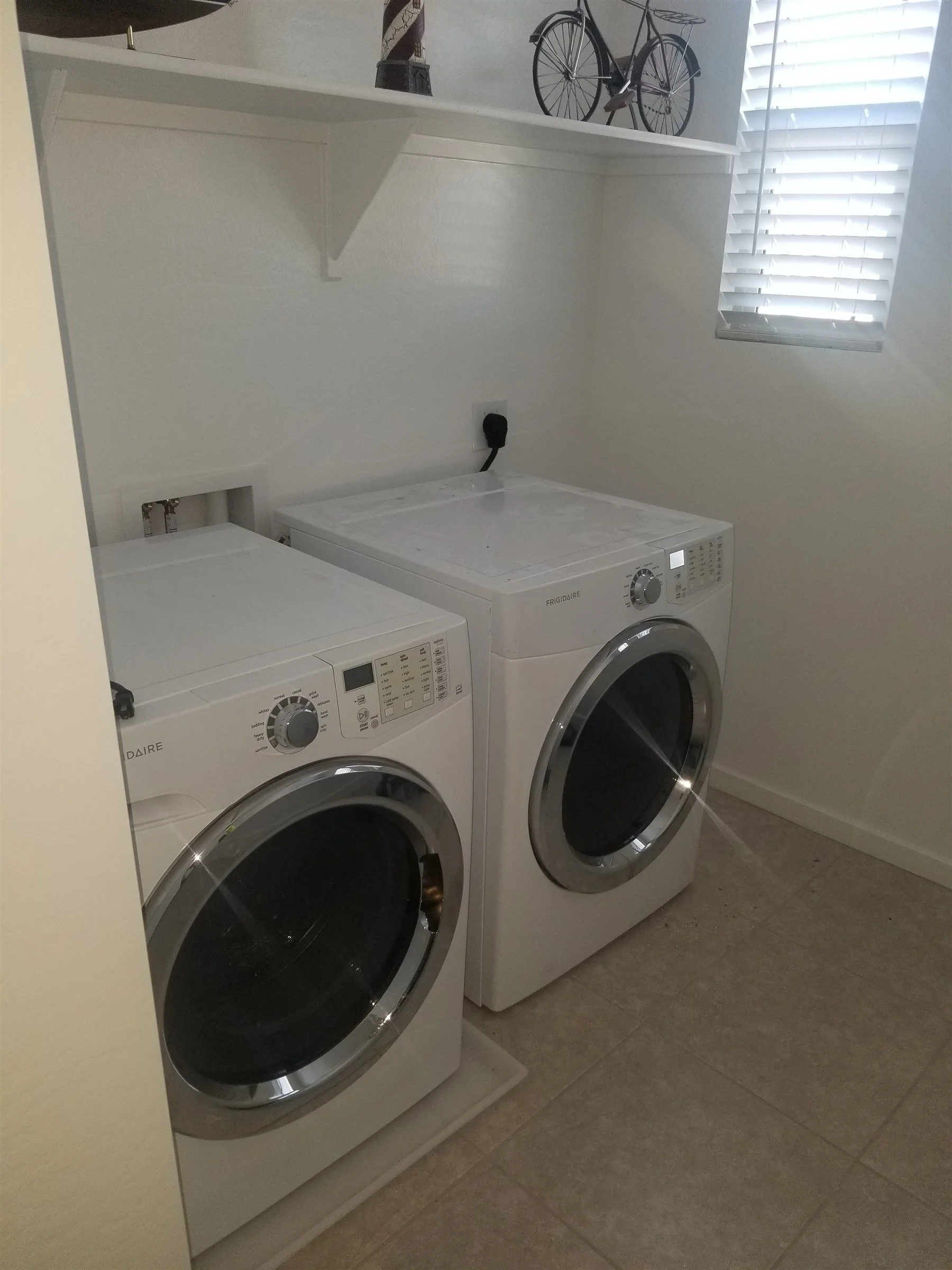Washer and dryer hooked up in a bright Phoenix laundry room