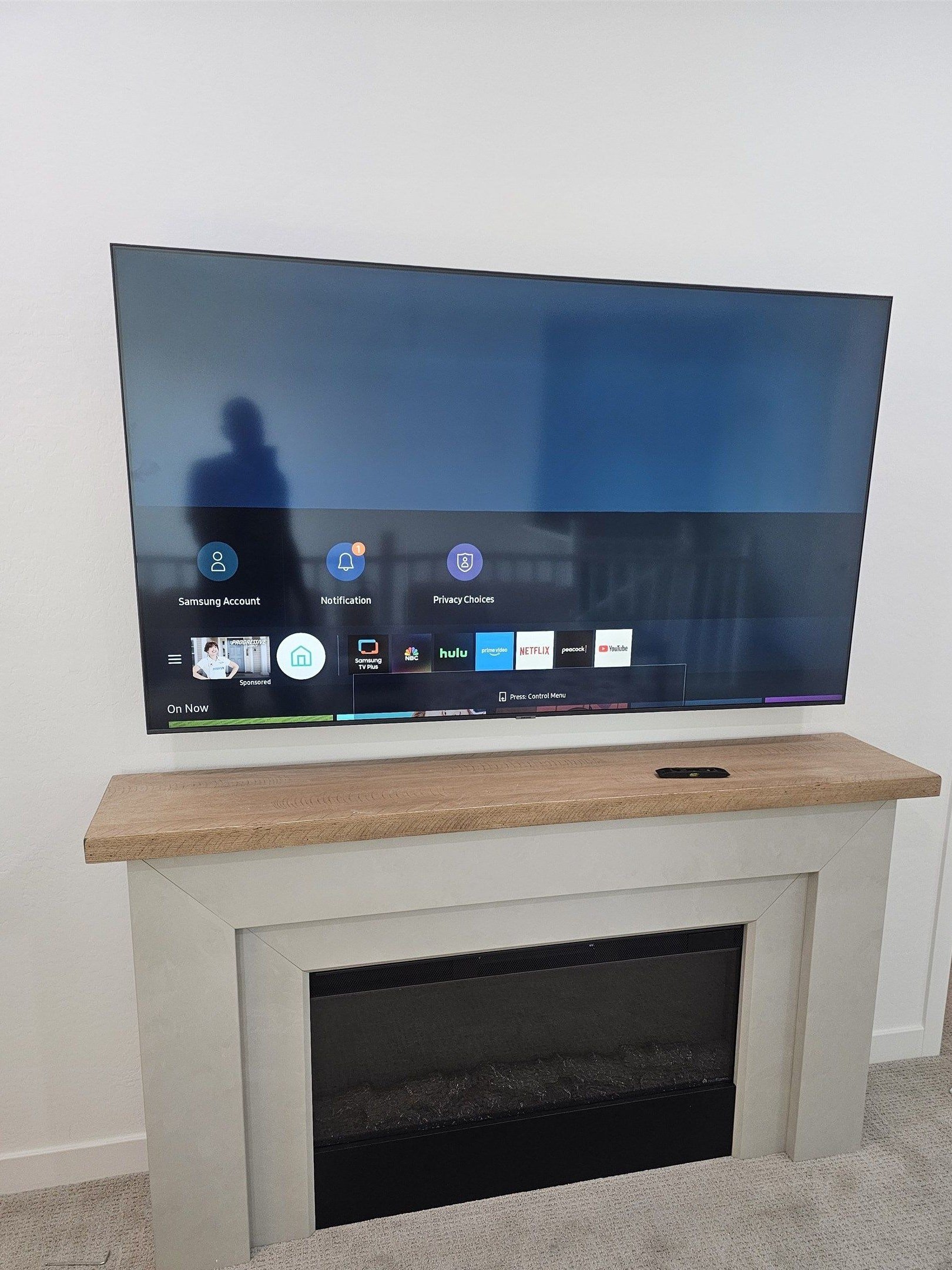 TV mounted above an electric fireplace mantel in a Phoenix home