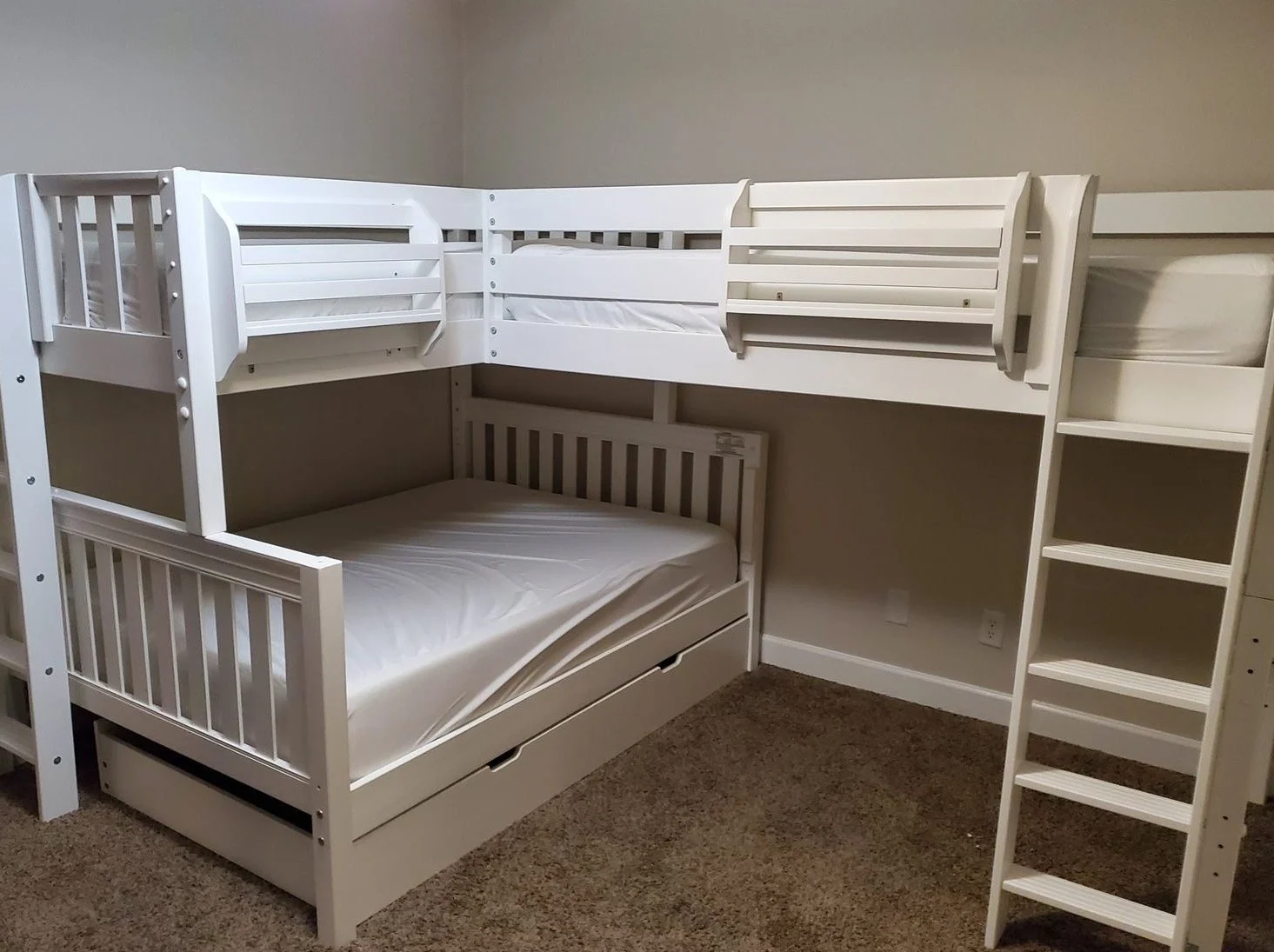 White L-shaped bunk beds with staircase assembled by Helping Hands
