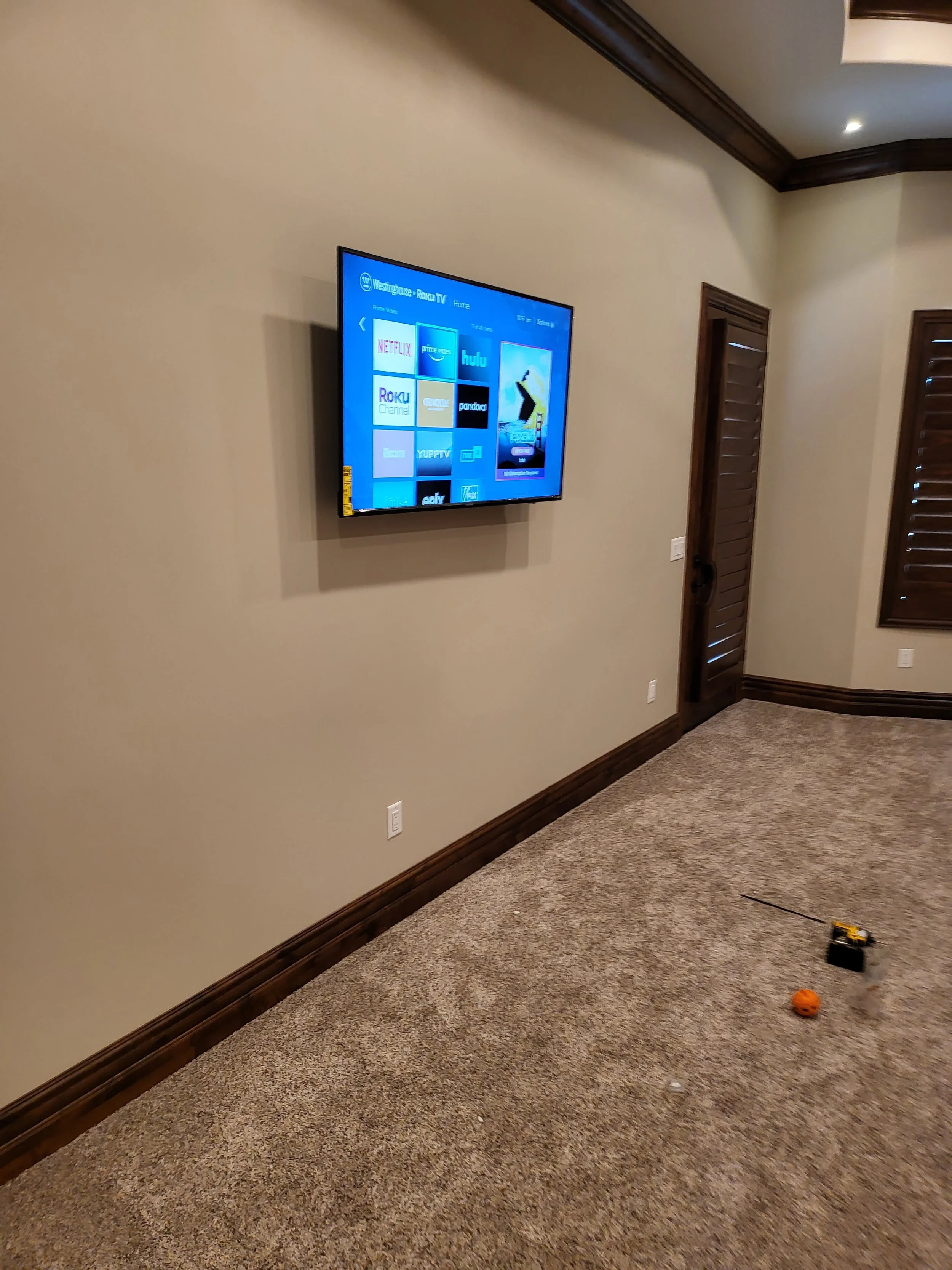 Commercial flat-screen display wall mounted in a Phoenix office suite, installed with heavy-duty drywall anchors and seamless concealed wiring in a professional workspace.