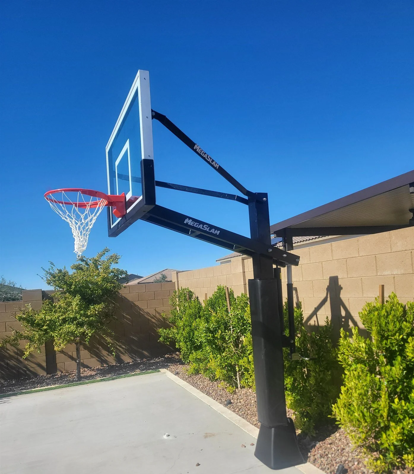 MegaSlam heavy-duty in-ground basketball goal installed beside a backyard court in Mesa