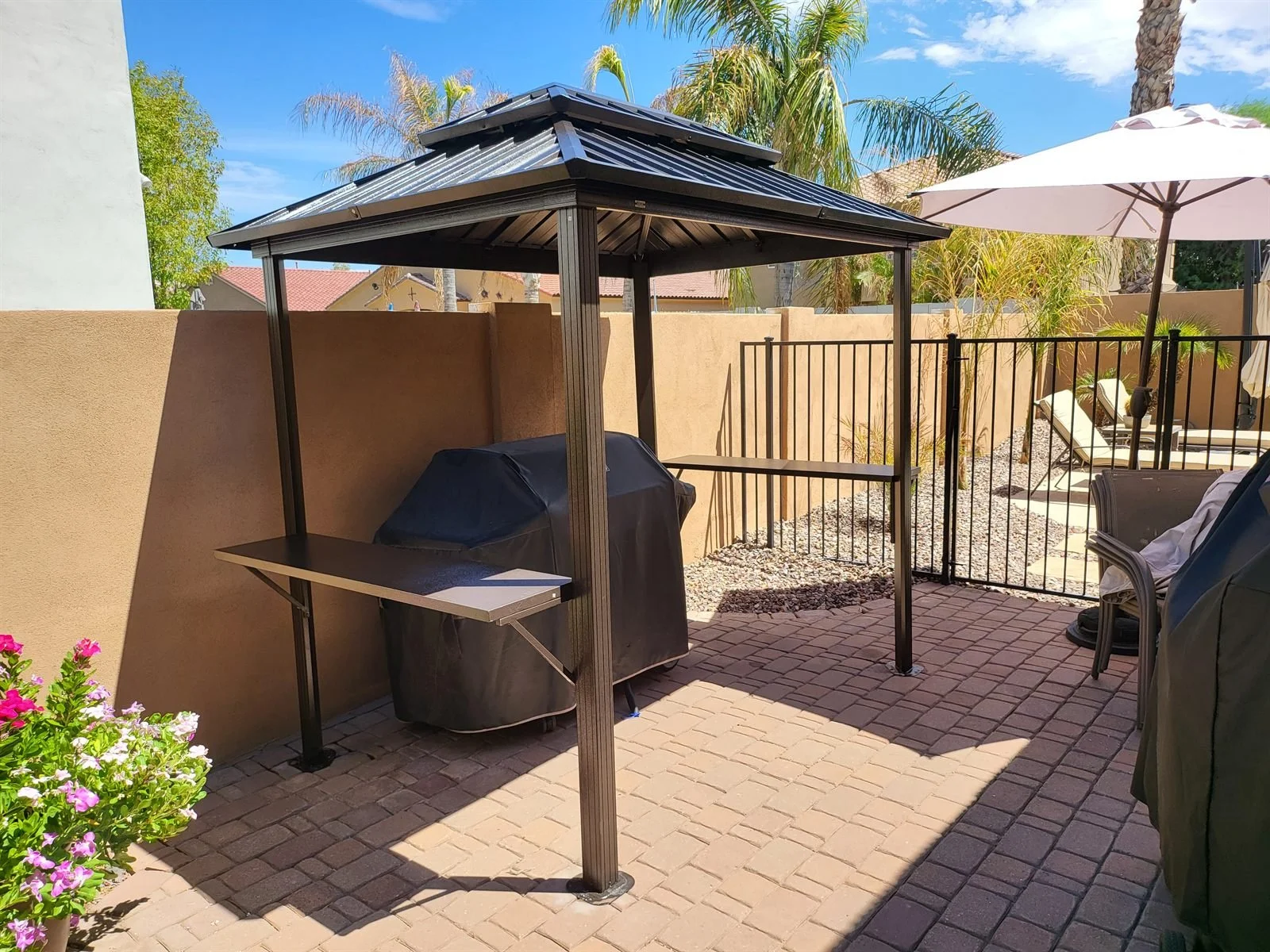 Grill master's new office: metal grill gazebo on pavers