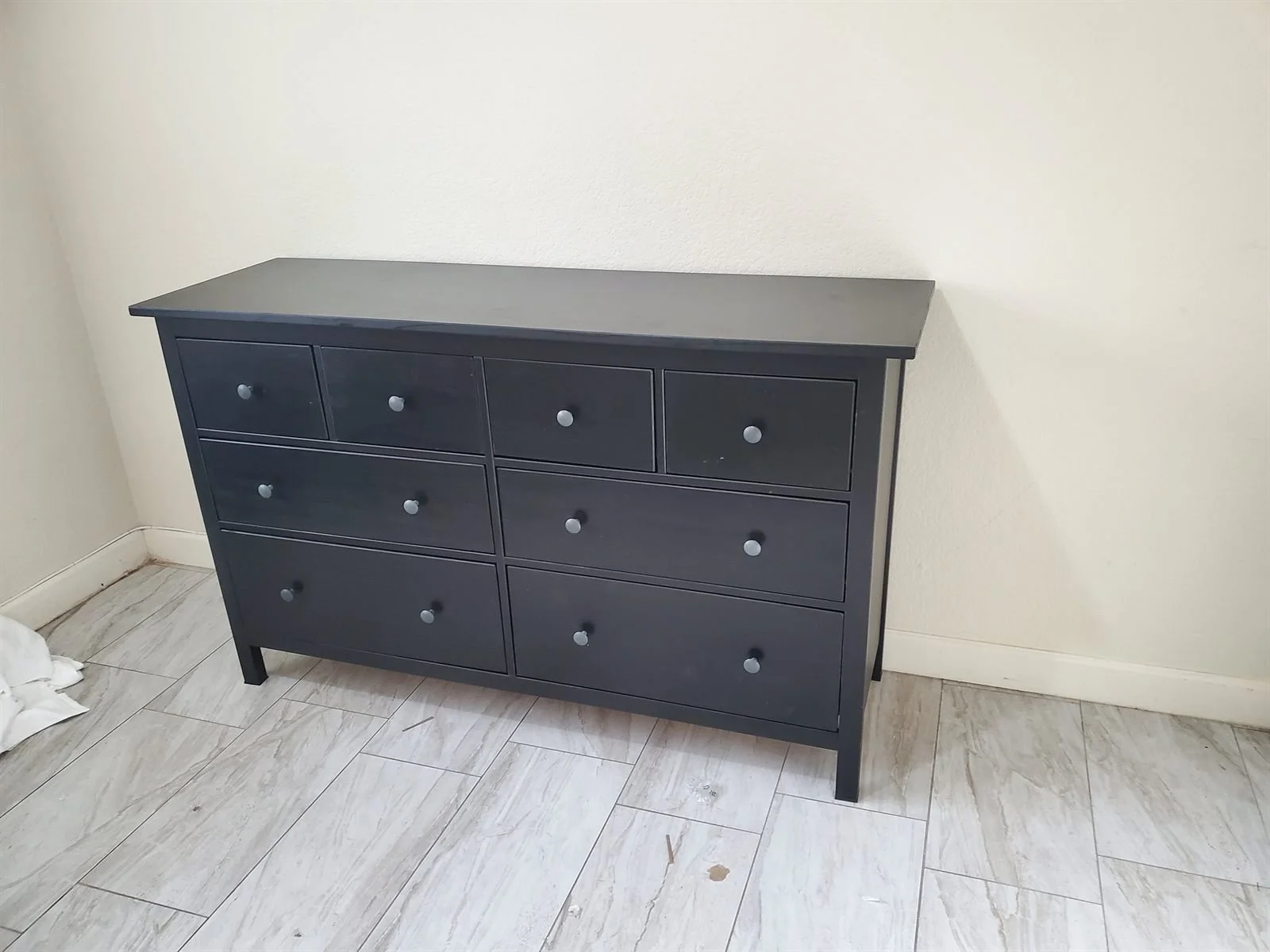 Black eight-drawer dresser assembled by Helping Hands in Phoenix