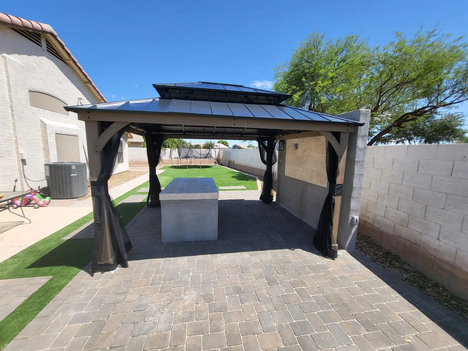 Happy hour, now with shade: hardtop gazebo over the outdoor bar