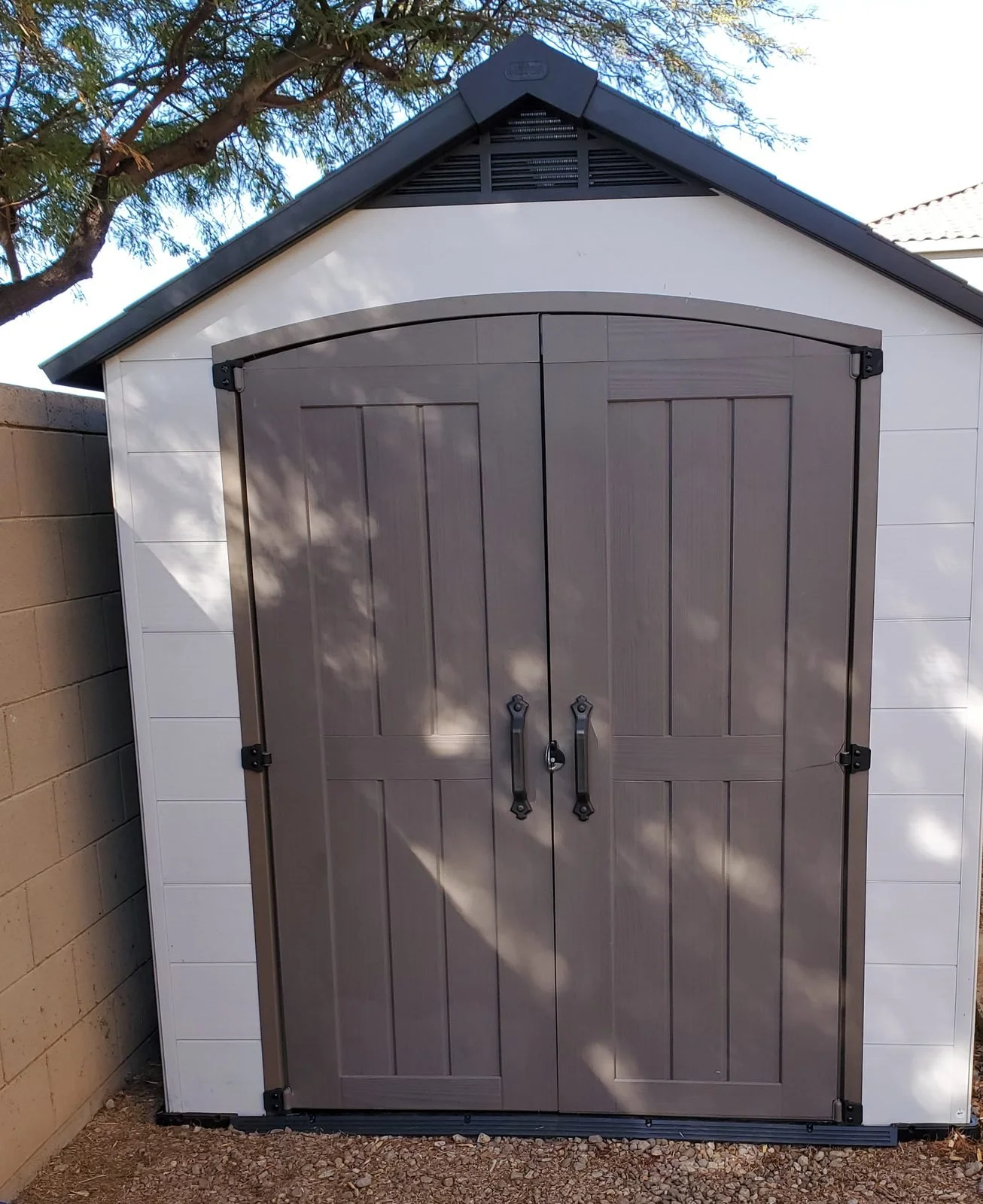 Keter resin storage shed with double doors assembled in a Phoenix, AZ backyard by Helping Hands Household Solutions