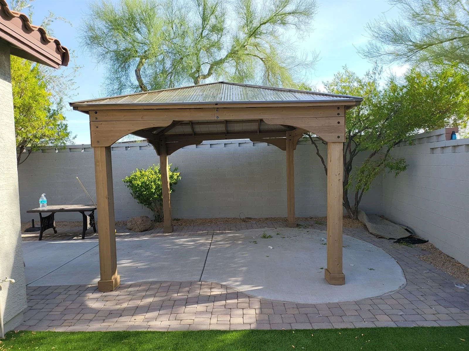 Plot twist: the patio is now the best room in the house (wood gazebo on concrete)