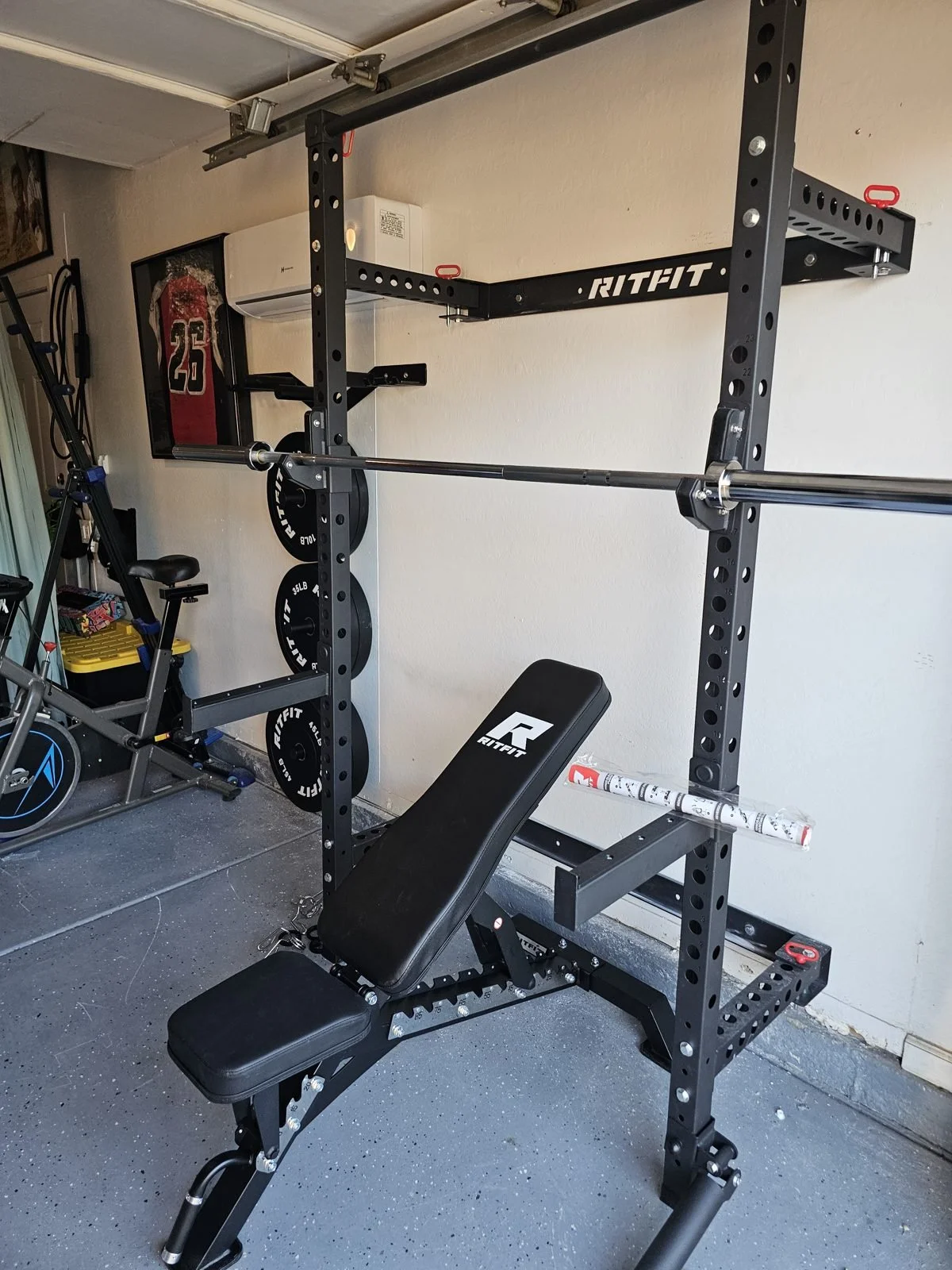 RitFit wall-mounted folding power rack and bench installed in a Phoenix garage gym