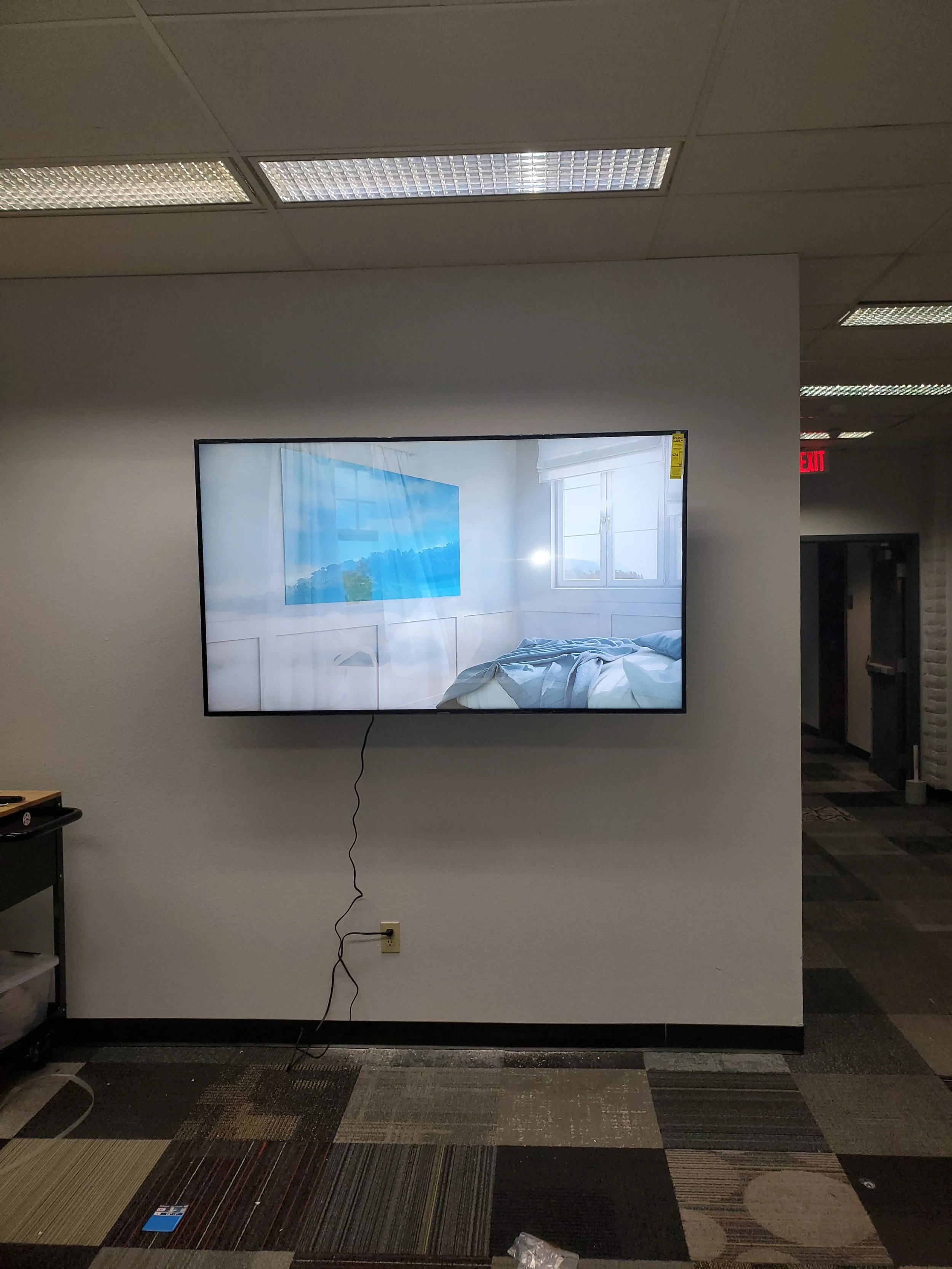 Commercial television wall mounting at Pensar Academy in Phoenix, AZ, featuring heavy-duty structural anchoring and clean in-wall wire concealment for school classrooms and common areas.