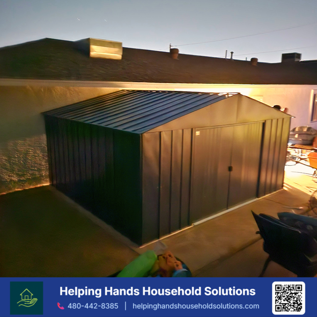 Arrow steel storage shed in navy blue with a  gable roof and vertical rib panel siding, installed on a concrete pad in a Phoenix, AZ backyard by Helping Hands Household Solutions — spacious galvanized steel construction captured at dusk, delivering d