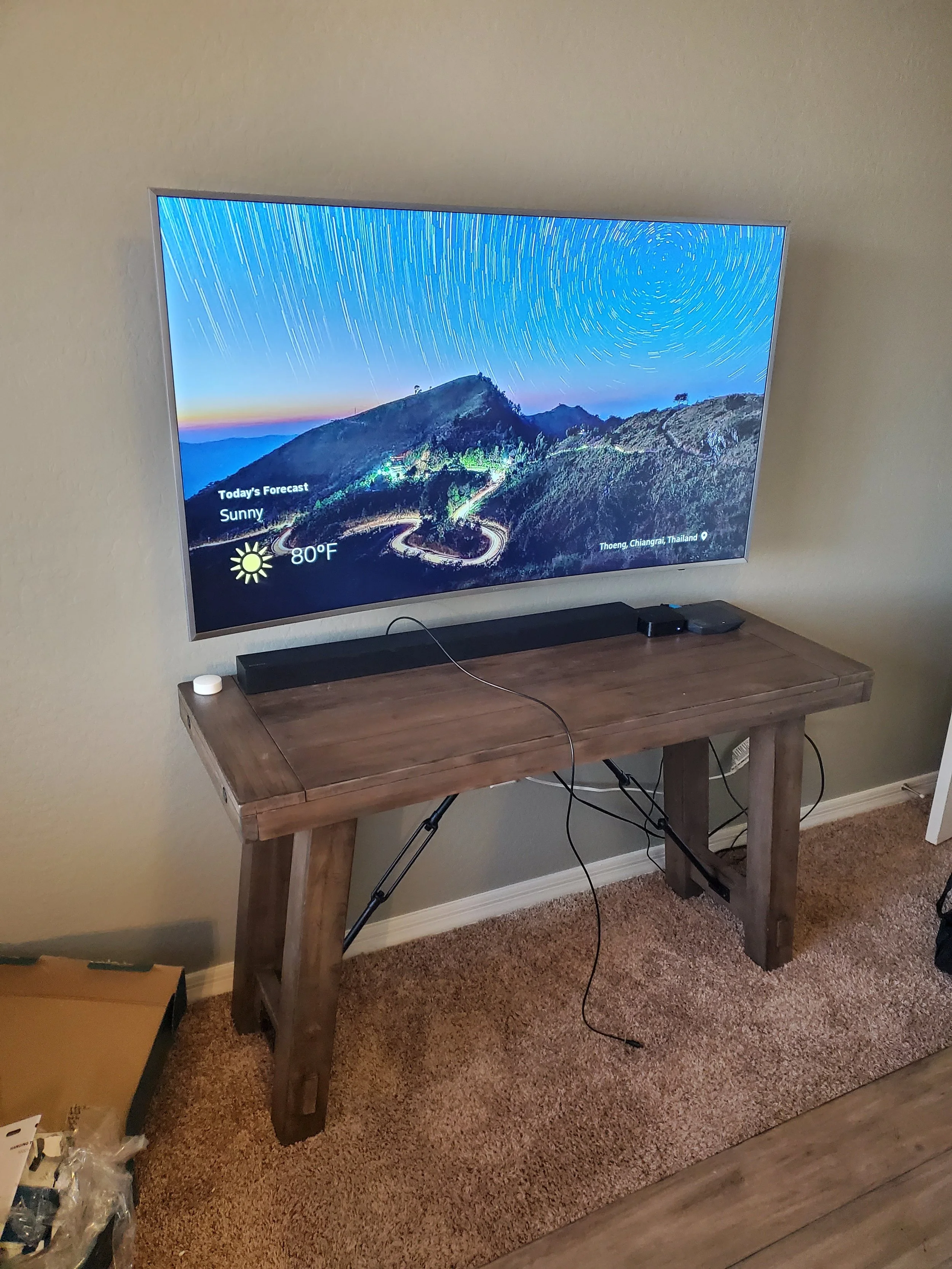 Medium‑sized TV mounted on drywall with integrated sound bar setup for enhanced audio and streamlined home theater design.