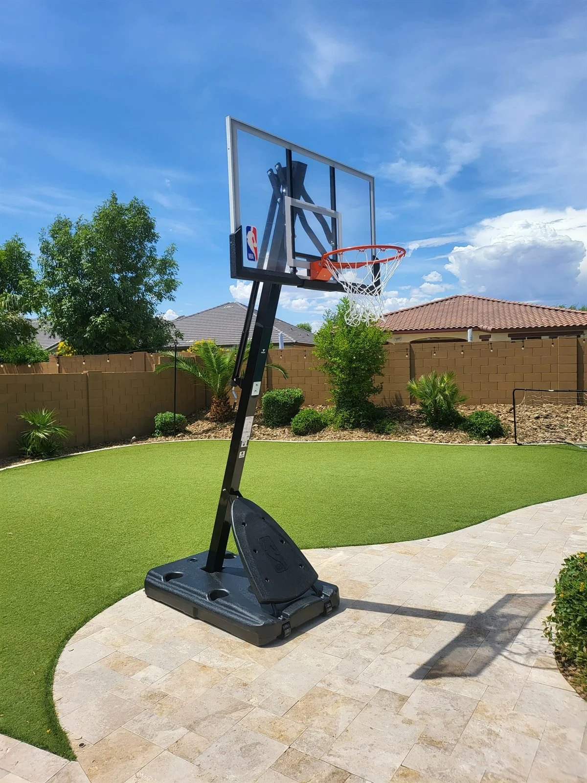 Spalding NBA portable basketball hoop assembled on artificial turf and travertine in Gilbert