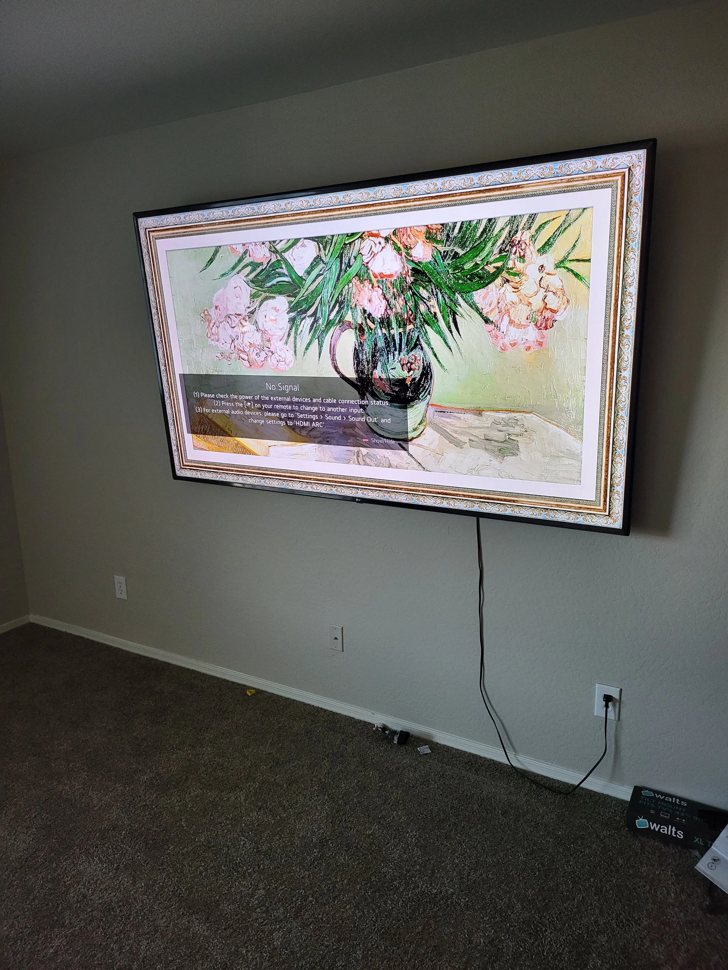 Samsung Frame TV wall mounting on a charcoal accent wall in Phoenix, AZ with custom white bezel fitting and secure flush-mount bracket installation.