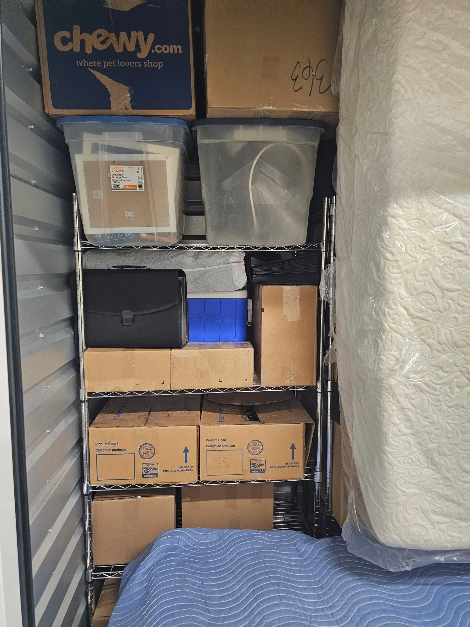 Storage unit organized with wire shelving, totes and boxes stacked in San Tan Valley, AZ