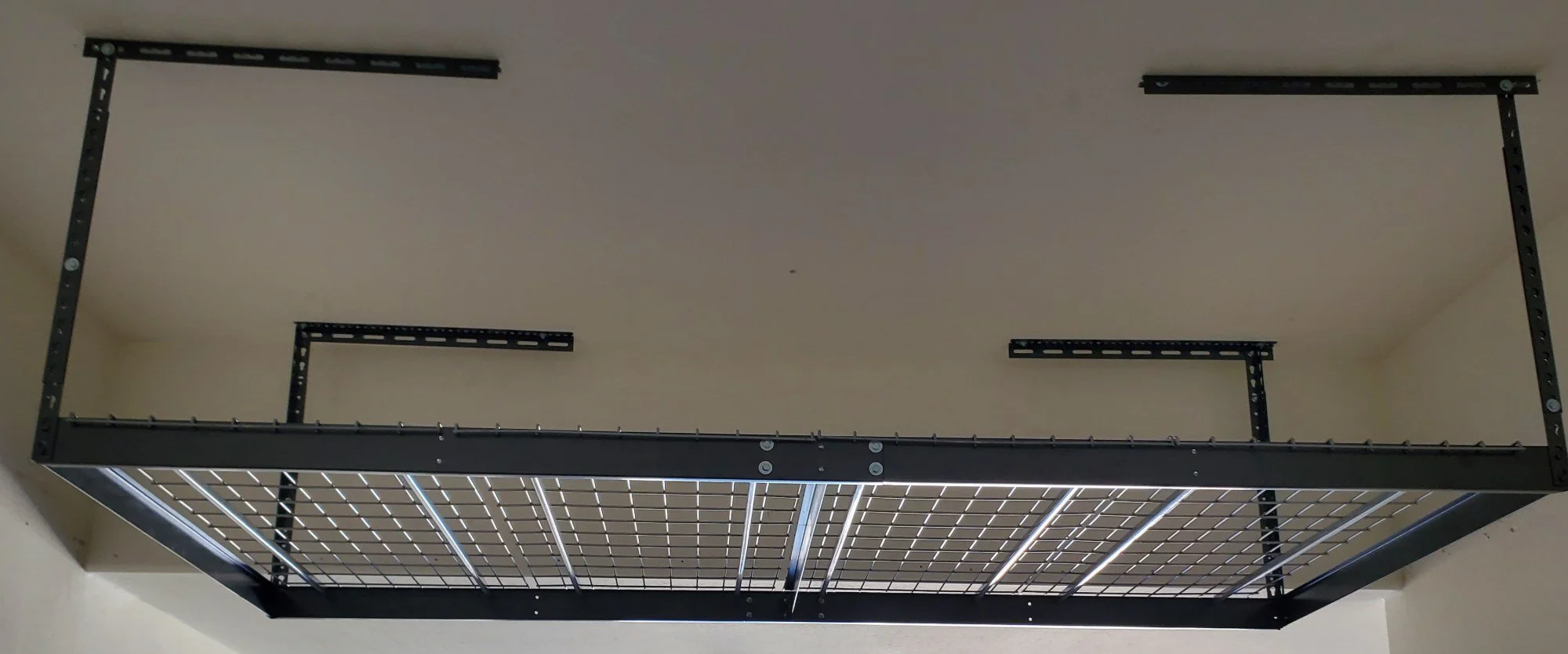 Overhead garage storage rack installed on the ceiling of an Avondale, AZ garage