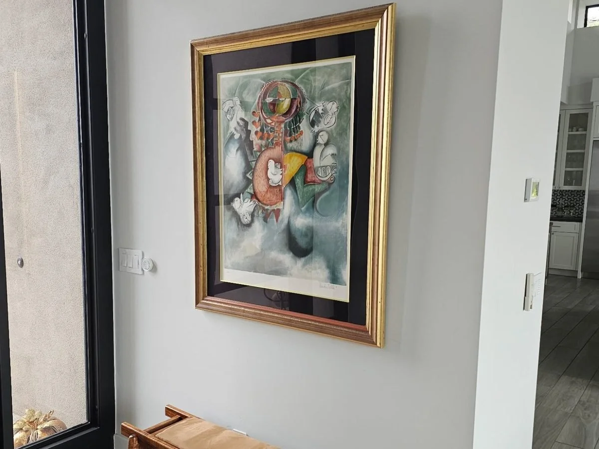 Framed artwork professionally hung in a Phoenix home