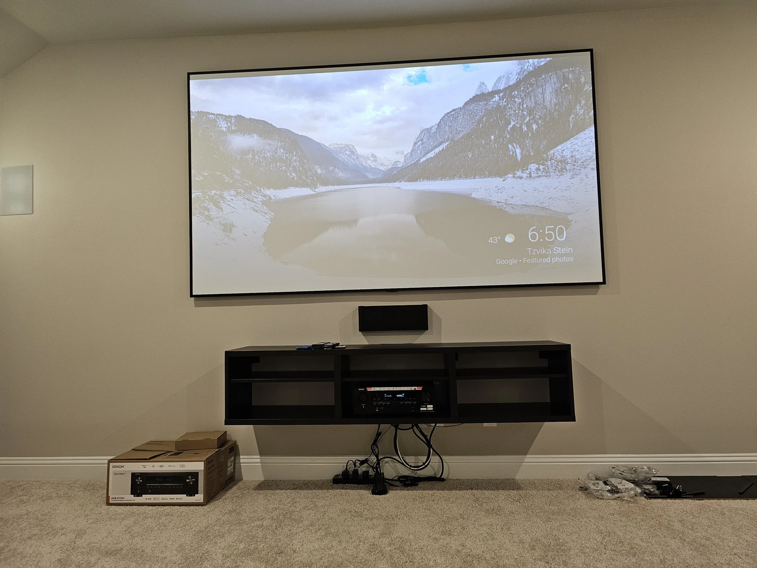 Professional 75-inch TV wall mounting with in-wall wire concealment above a living room media console in Happy Valley, Phoenix, AZ.