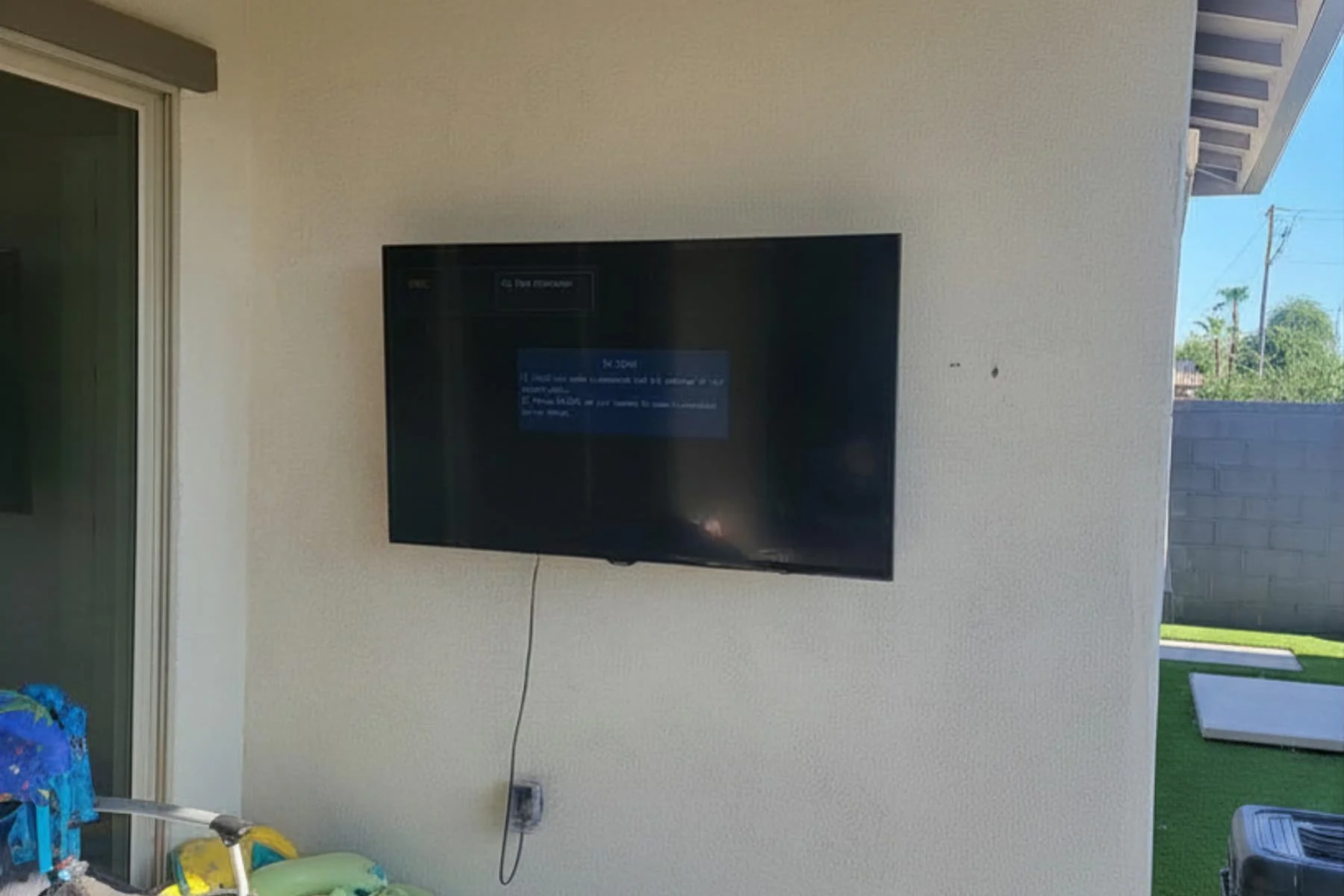 Outdoor patio stucco TV mount installation, weatherproof setup in Phoenix, AZ