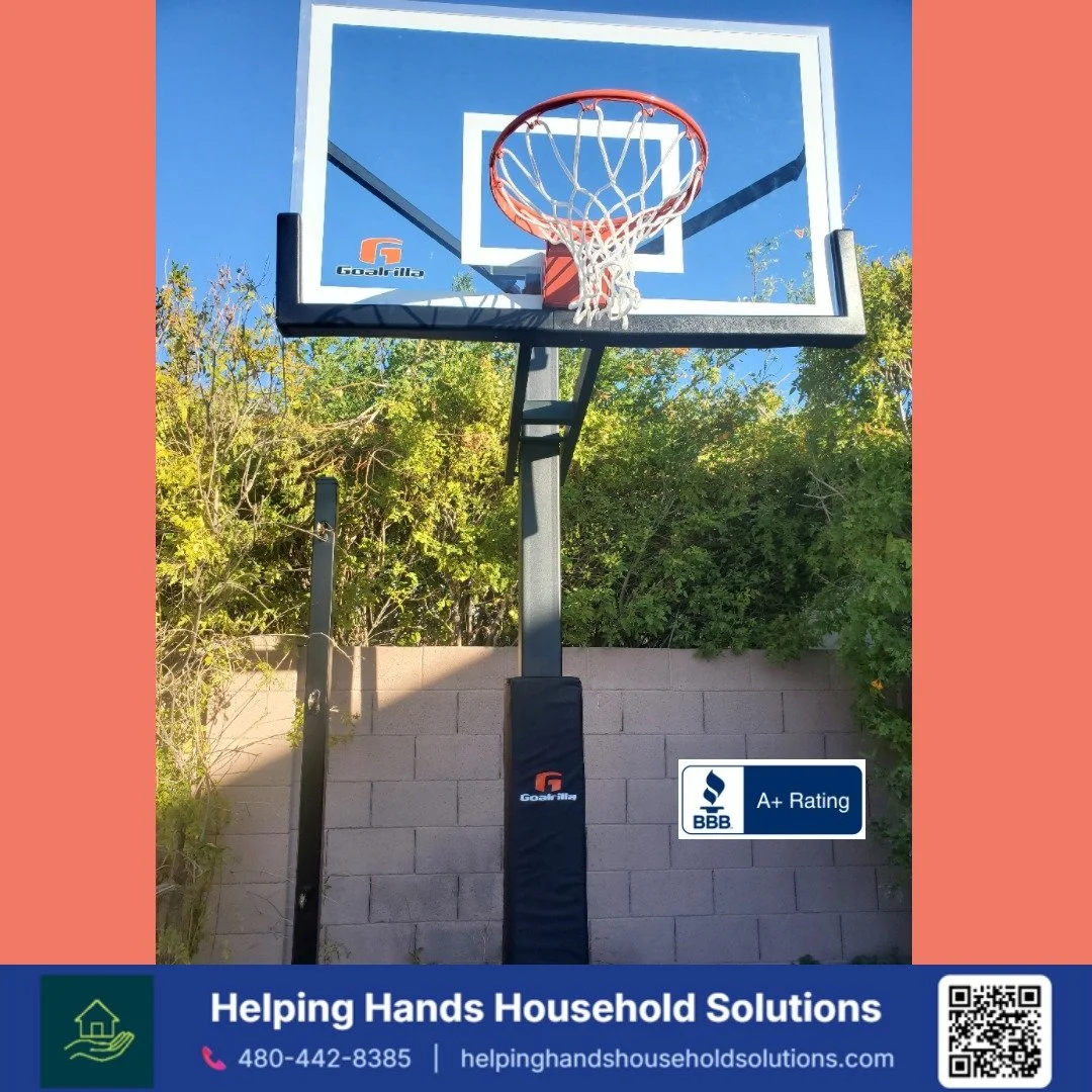 Portable basketball hoop assembly on a driveway in a Phoenix, AZ front yard by Helping Hands Household Solutions — fast, affordable handyman assembly with same-day online scheduling available.