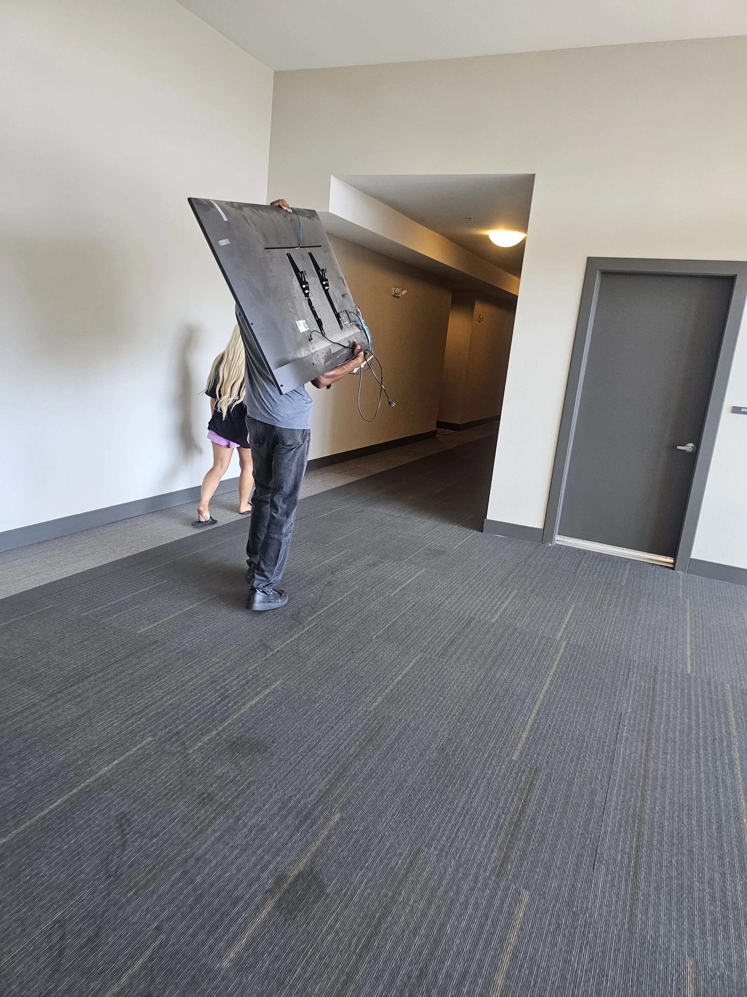 Turnkey TV unmounting, relocation, and remounting service for a Phoenix apartment move, featuring safe screen disassembly, transport, and secure wall anchoring at the new location.