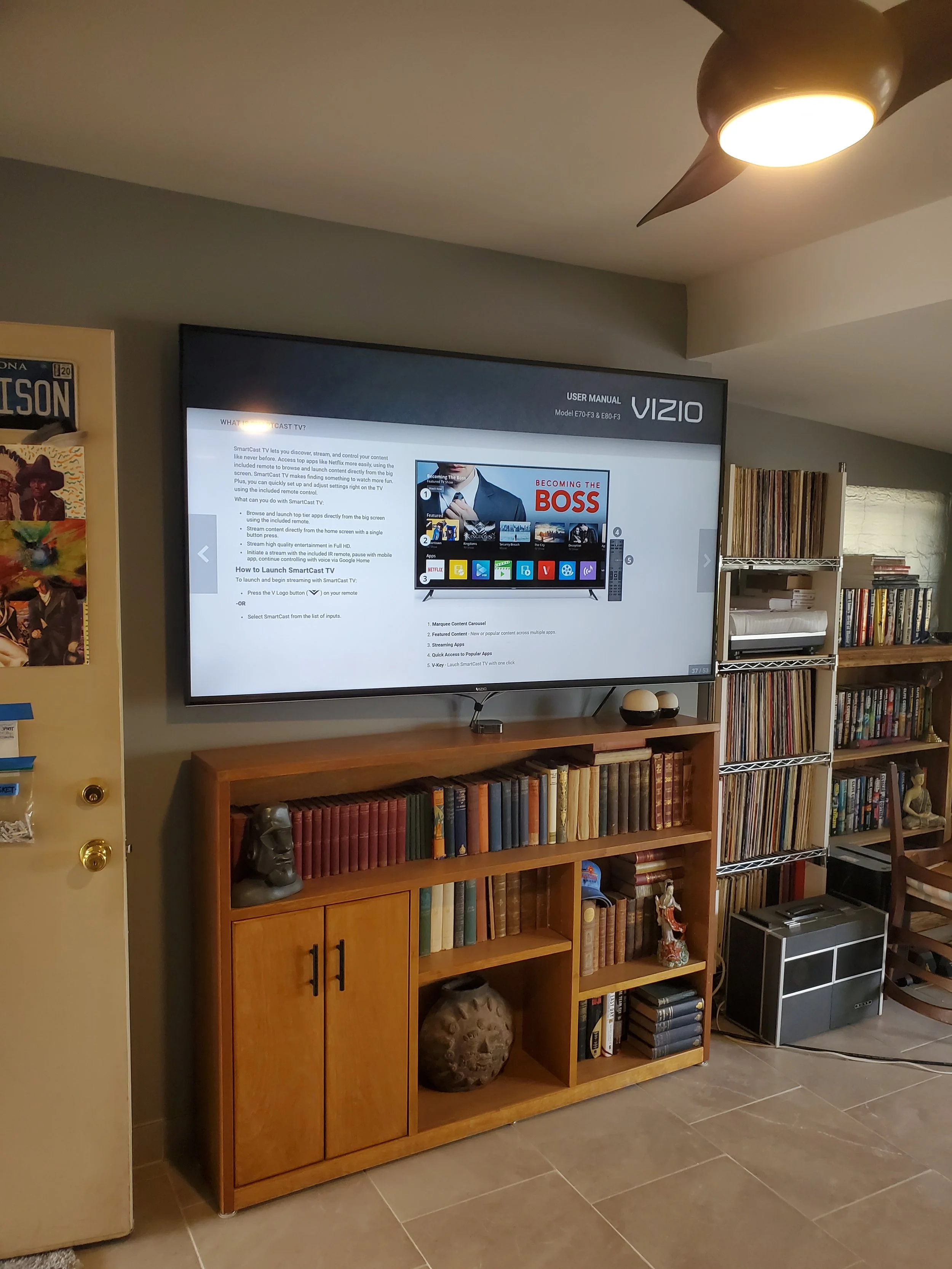 Precision wall-mounted television installed above media shelving, engineered with custom behind-wall cable management for a clean, clutter-free entertainment setup.