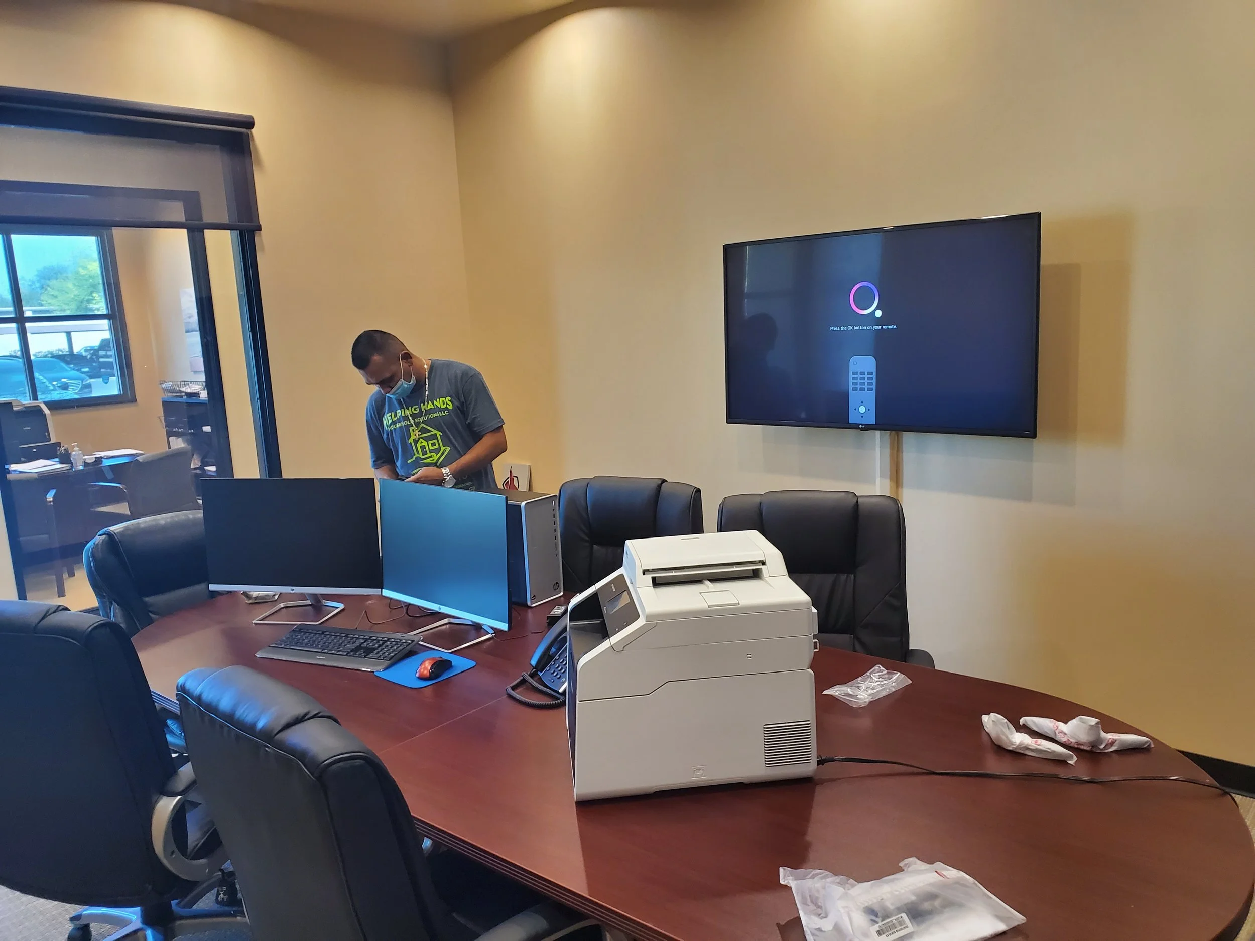 Commercial conference room TV wall mounting in Phoenix, AZ, featuring precision wall anchoring and sleek surface raceway cord concealment along the wall for a clean meeting space.