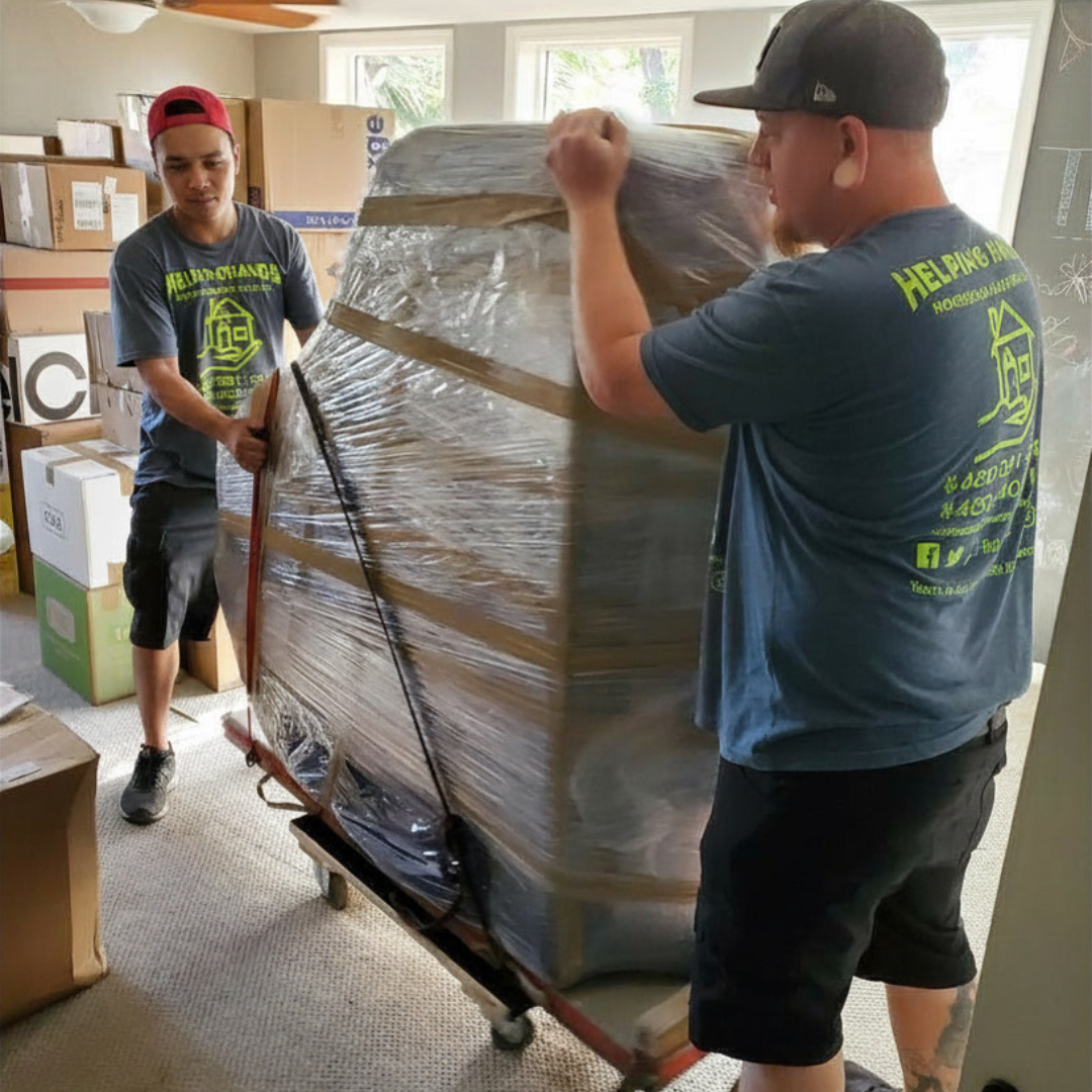 Helping Hands Household Solutions' experienced movers transporting a piano from insdie the home to a customer's garage.