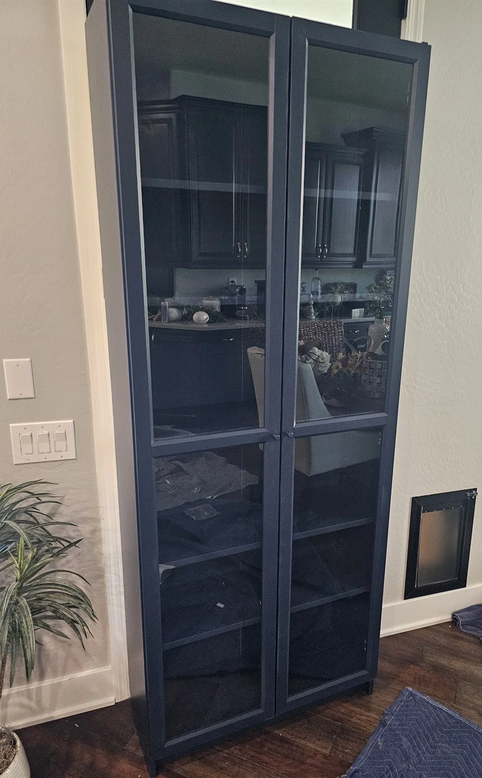 Navy IKEA BILLY bookcase with OXBERG glass doors assembled in a Scottsdale home