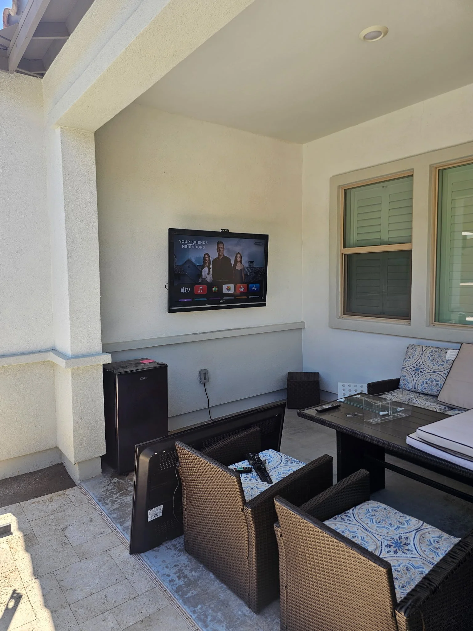 Outdoor patio TV wall mounting on exterior stucco in Phoenix, AZ with weatherproof anchoring and clean wire management.