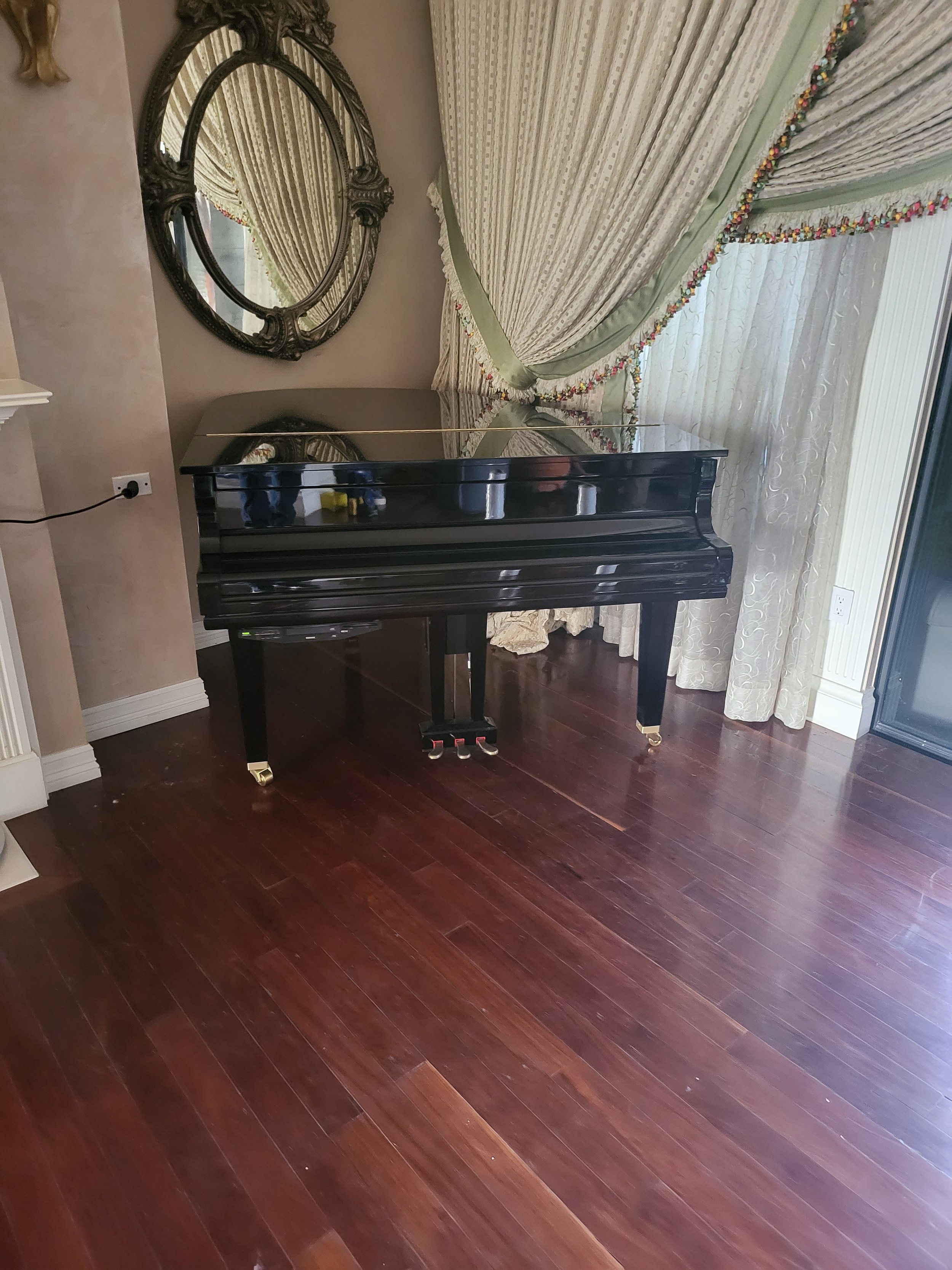Baby grand piano moved in the Waldorf Astoria Resort by Helping Hands Household Solutions' movers.