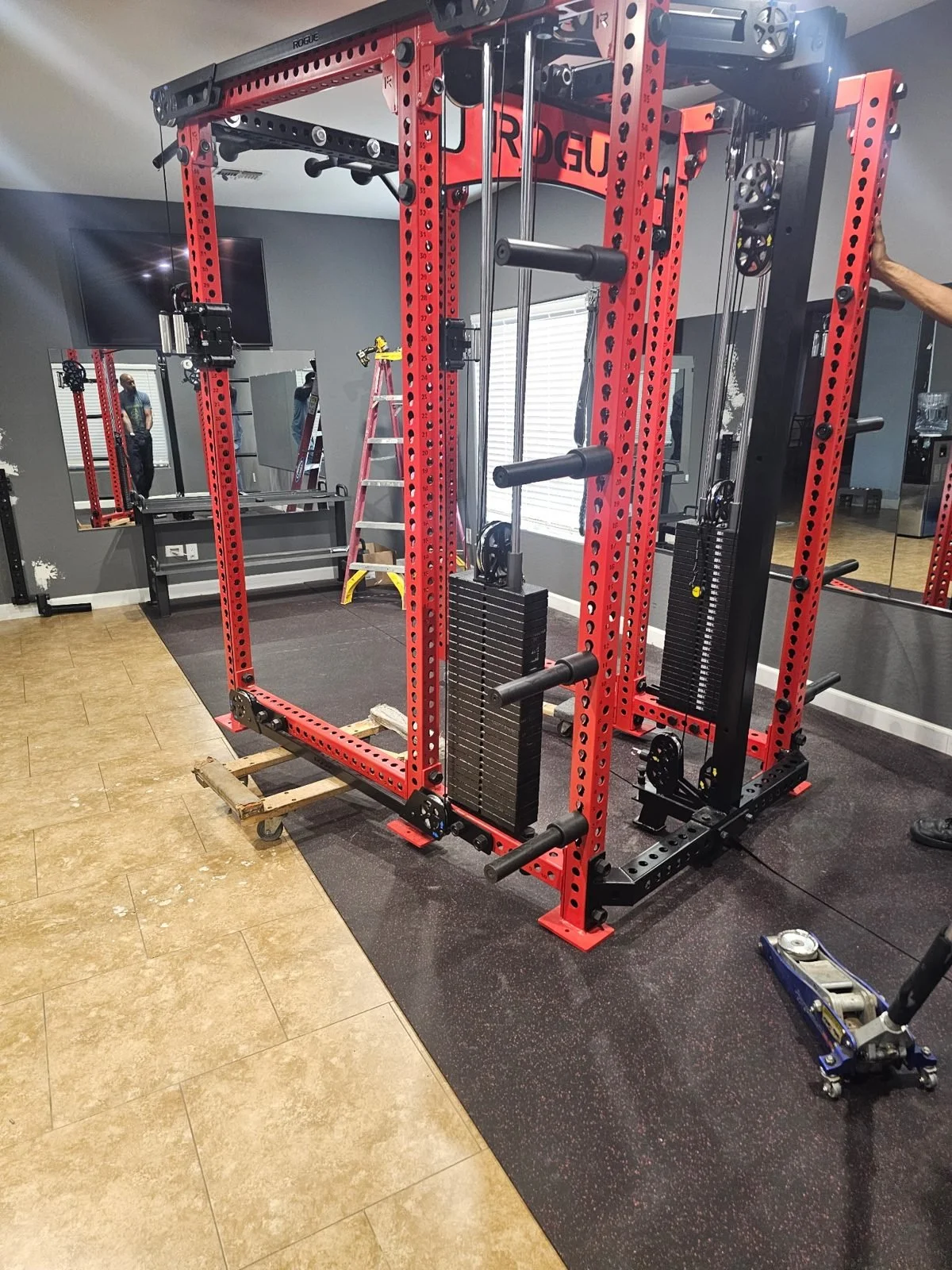 Rogue home gym rack on moving dollies during an in-home move in Phoenix