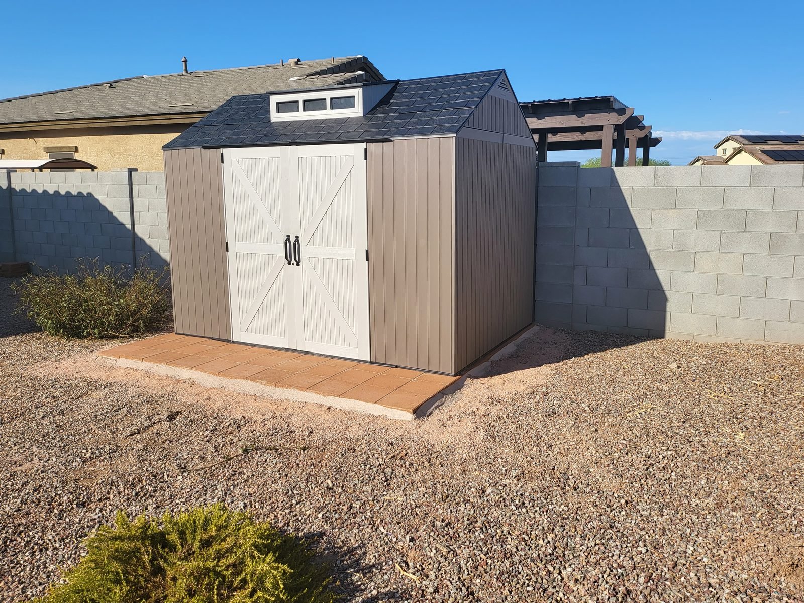 Rubbermaid resin storage shed assembled on a paver pad by Helping Hands shed installers in Phoenix AZ