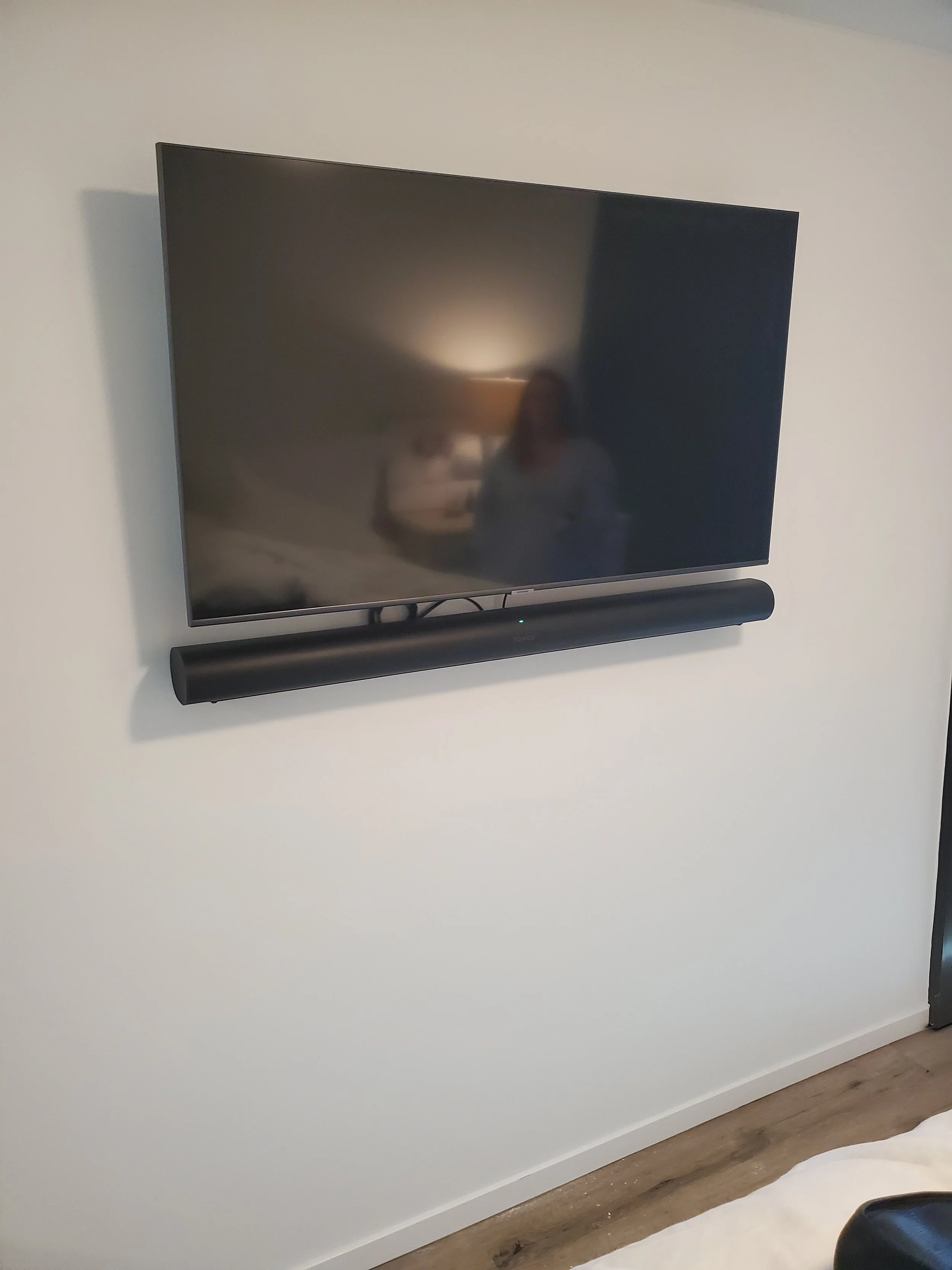 Flush TV and soundbar wall mounting in a Phoenix home, featuring precise dual-bracket alignment and complete in-wall cable concealment.