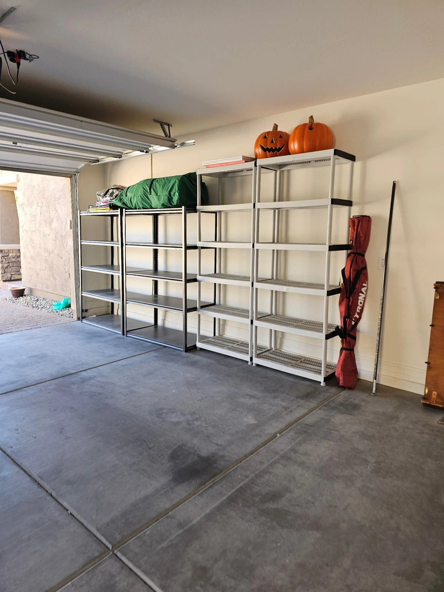 Four garage shelving units assembled and lined up along the wall of a Terravita, Scottsdale garage