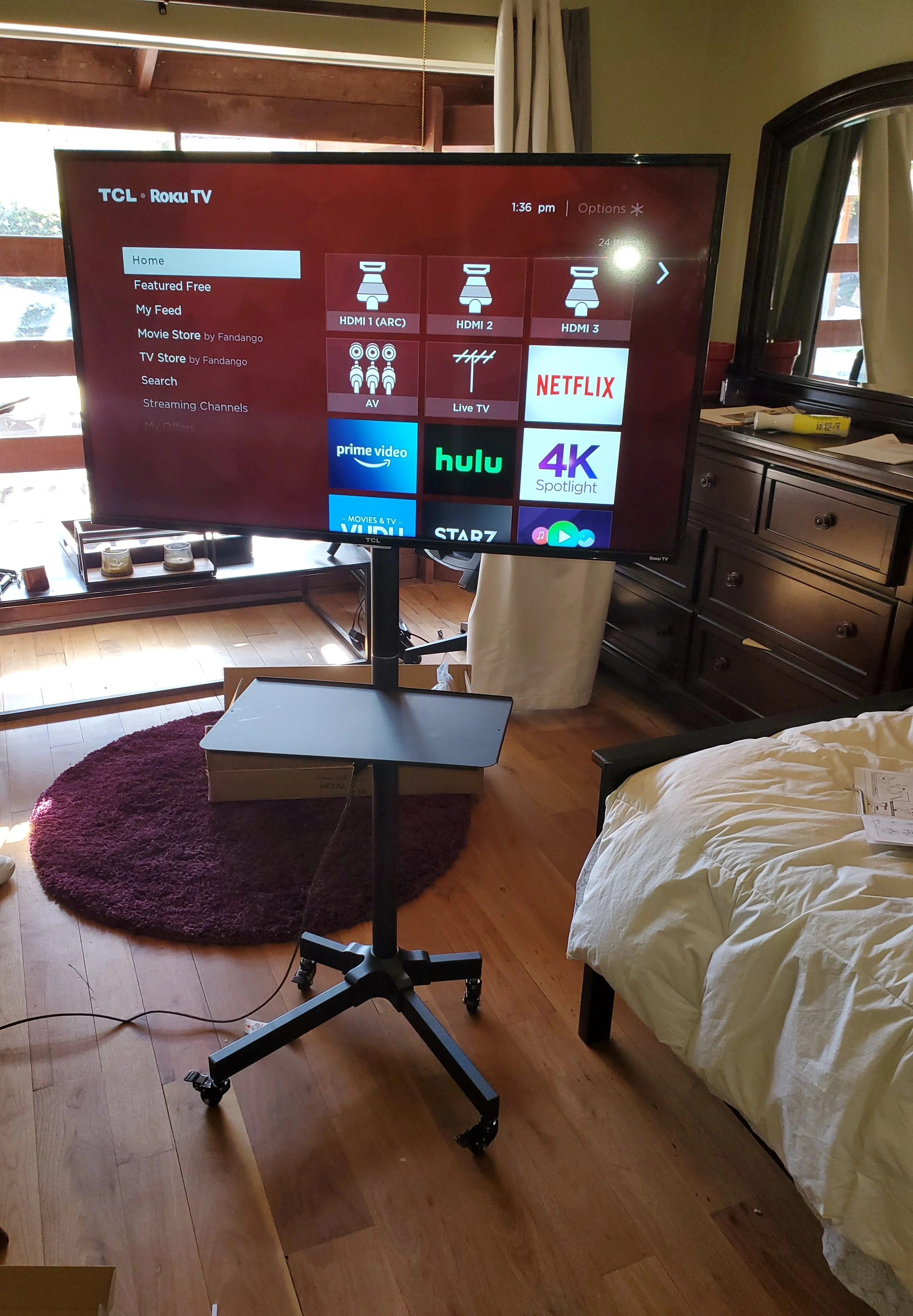 Heavy-duty mobile TV cart assembly and commercial display setup in a Phoenix office conference room, featuring a height-adjustable rolling AV stand with integrated cable management for portable presentations.