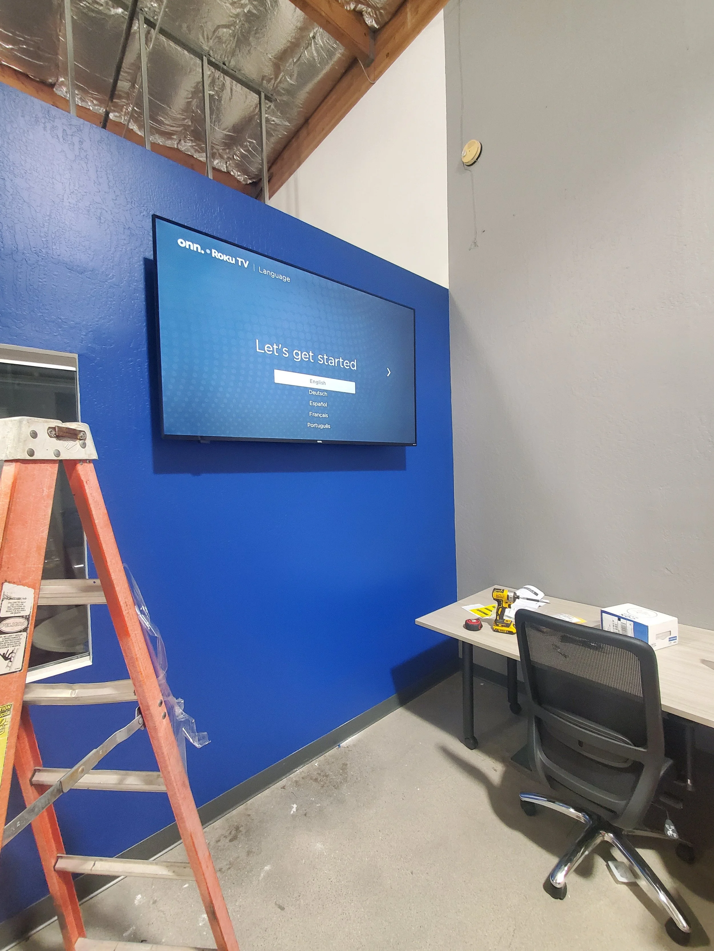 Commercial TV wall mounting for corporate office space in Phoenix, AZ featuring heavy-duty wall anchoring and clean commercial wire management.