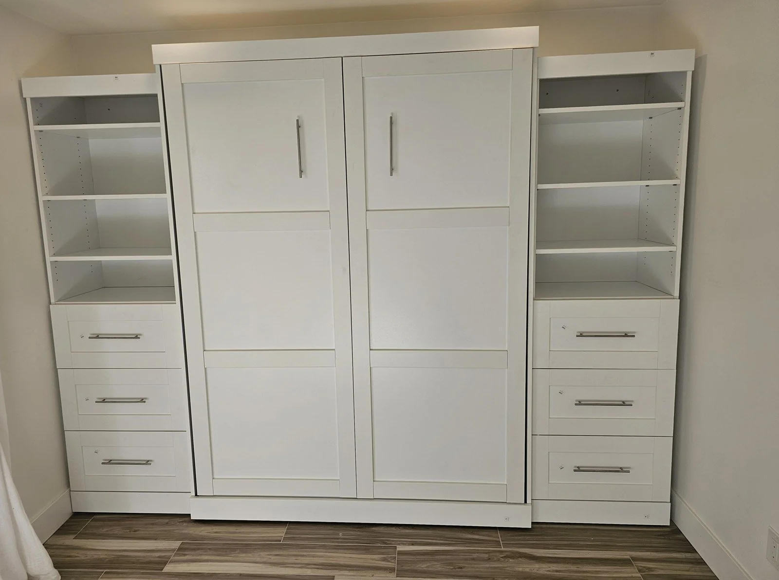 Murphy bed with side storage wall installed by Helping Hands in Phoenix