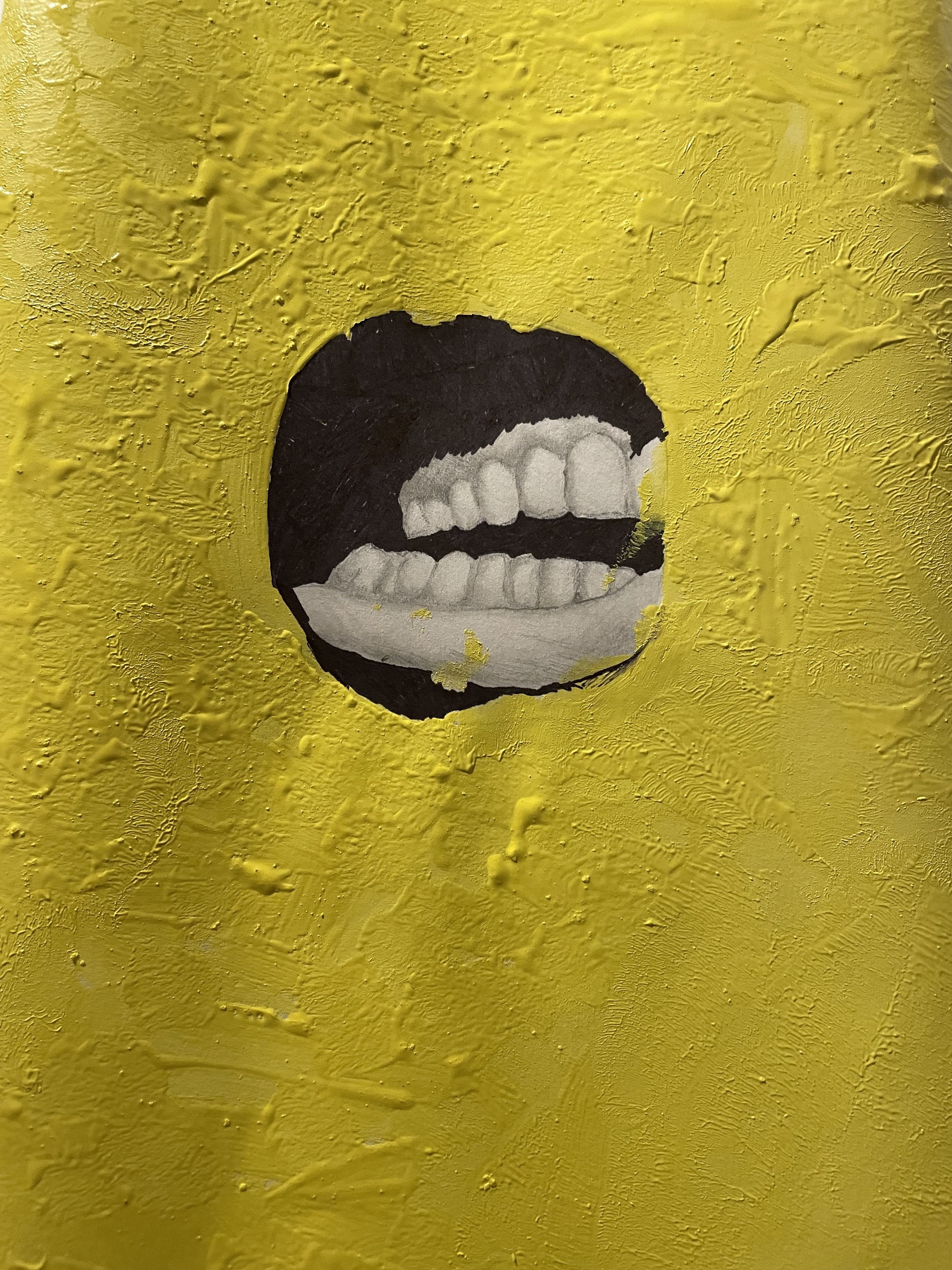A textured yellow surface with a hole in the center revealing a painted black and white mouth with teeth.