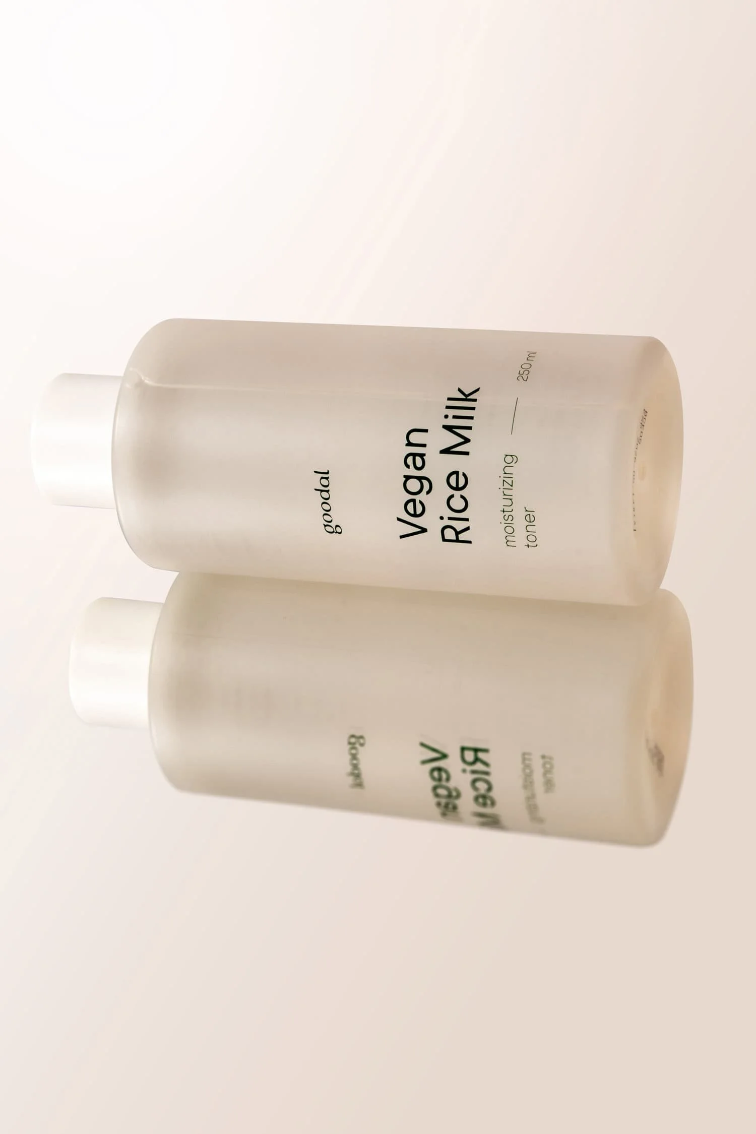 Simple product photo of Goodal Vegan Rice Milk lying on its side with a reflection underneath