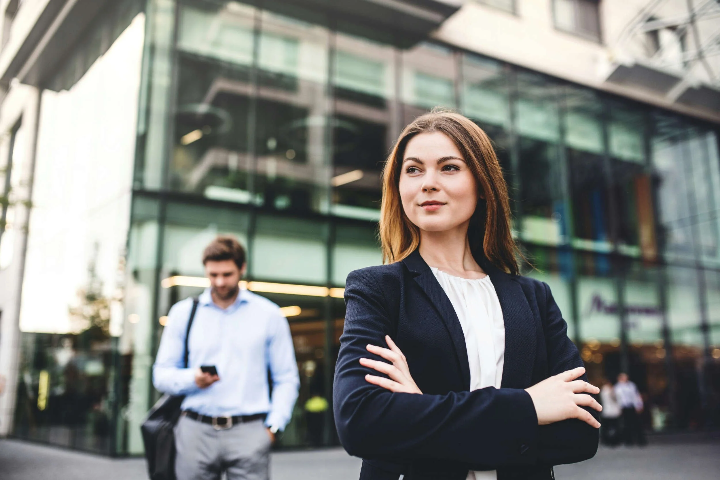 A women with a business suit on outside with her arms crossed - AI and the future of work