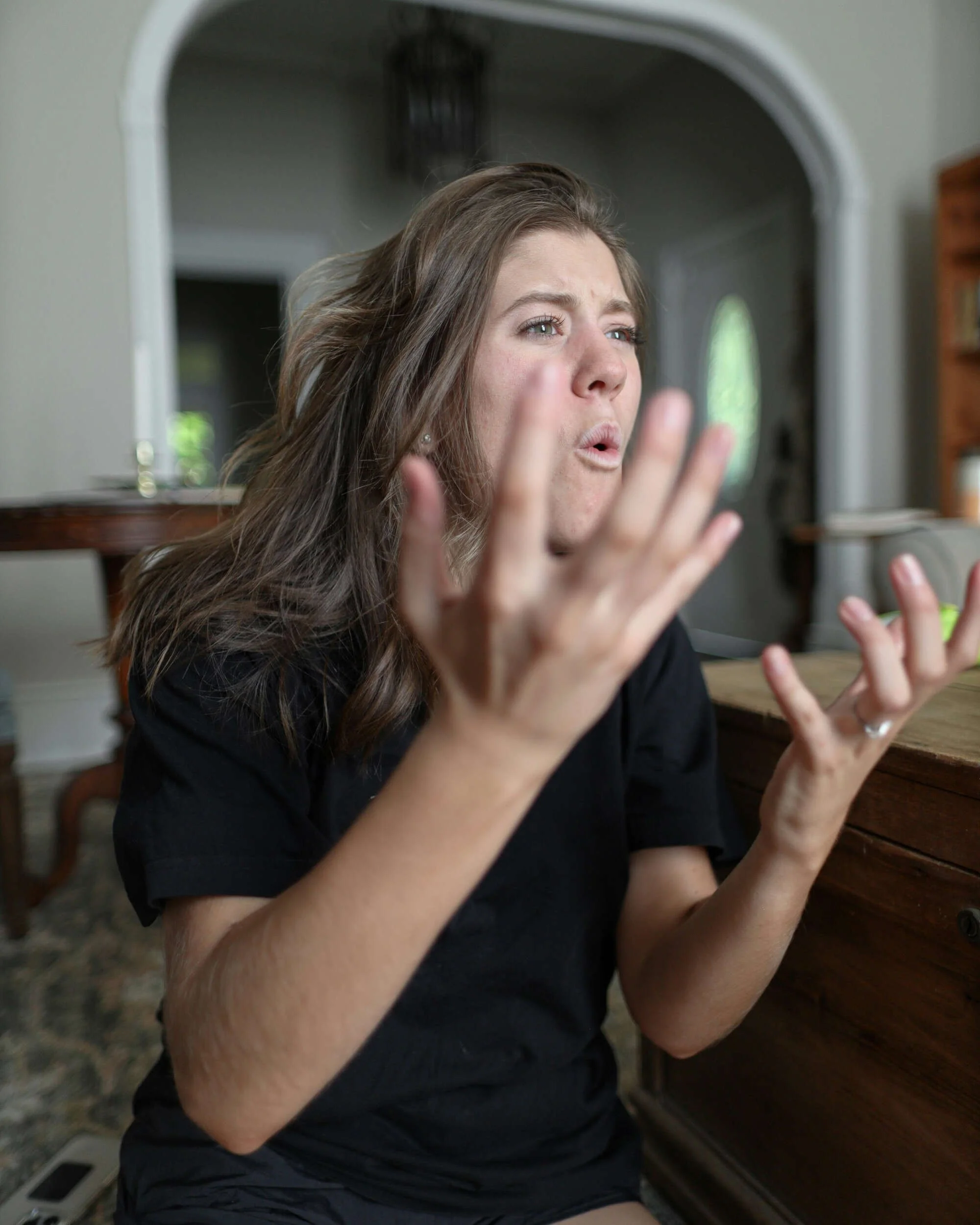 A women with both hands in the air frustrated - imposter syndrome at work