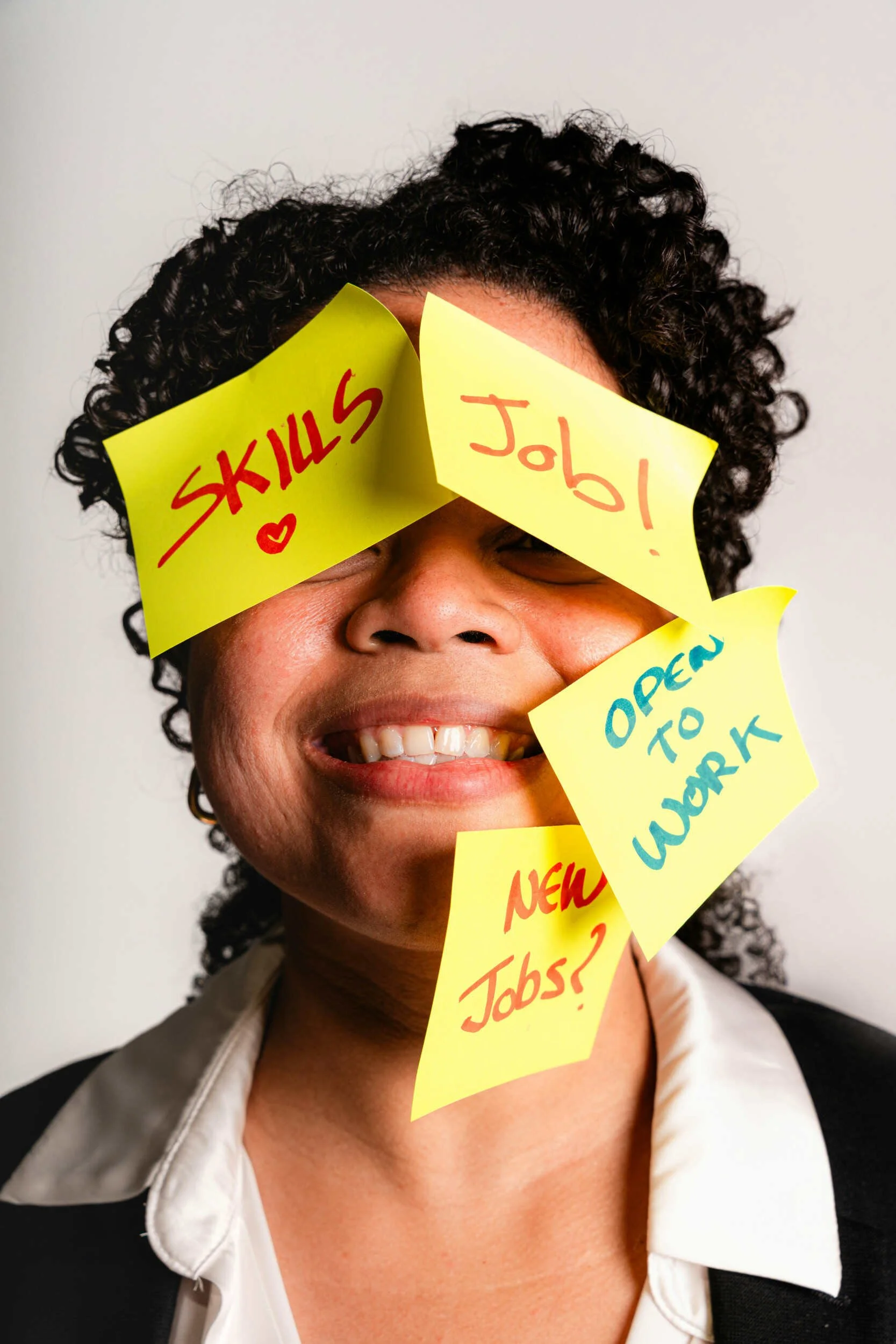 A black womens face with post its on it - transferable skills