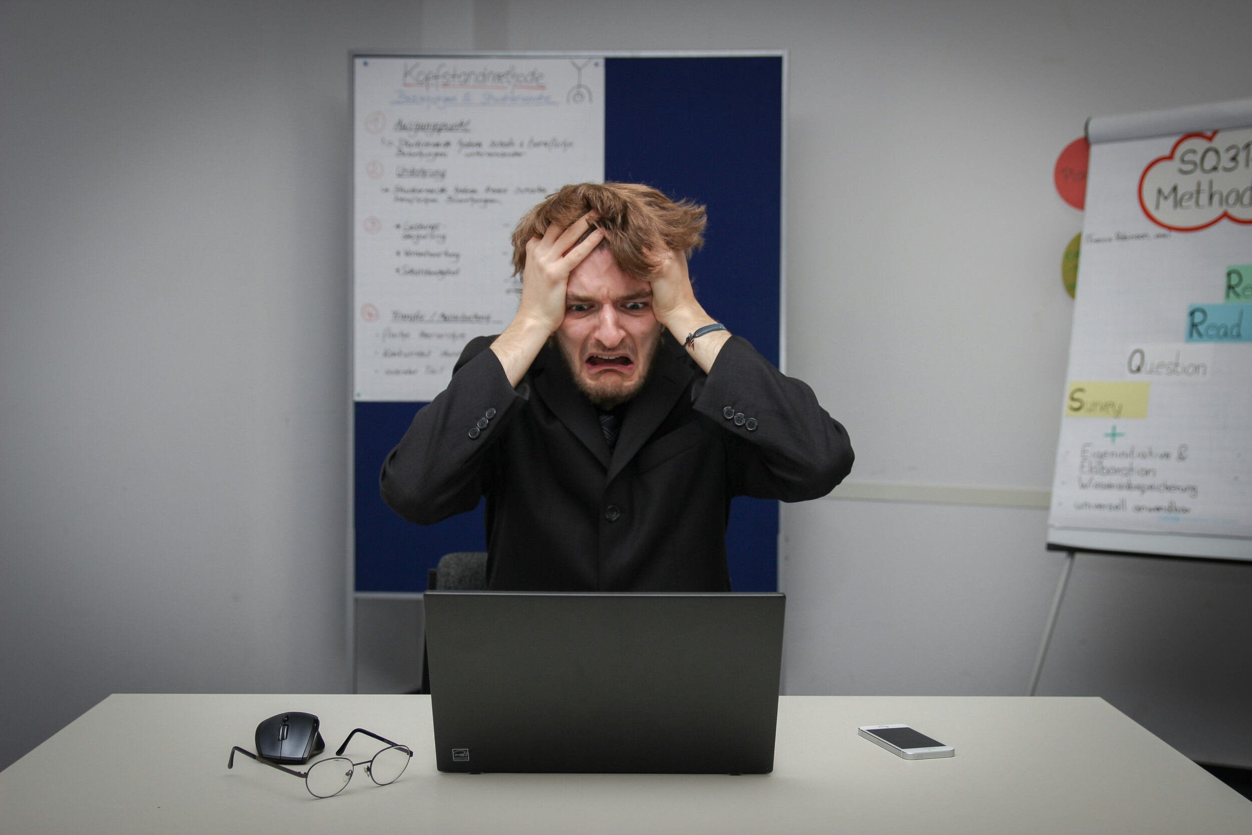A man with red hair pulling his hair out he's so frustrated - job search after layoff