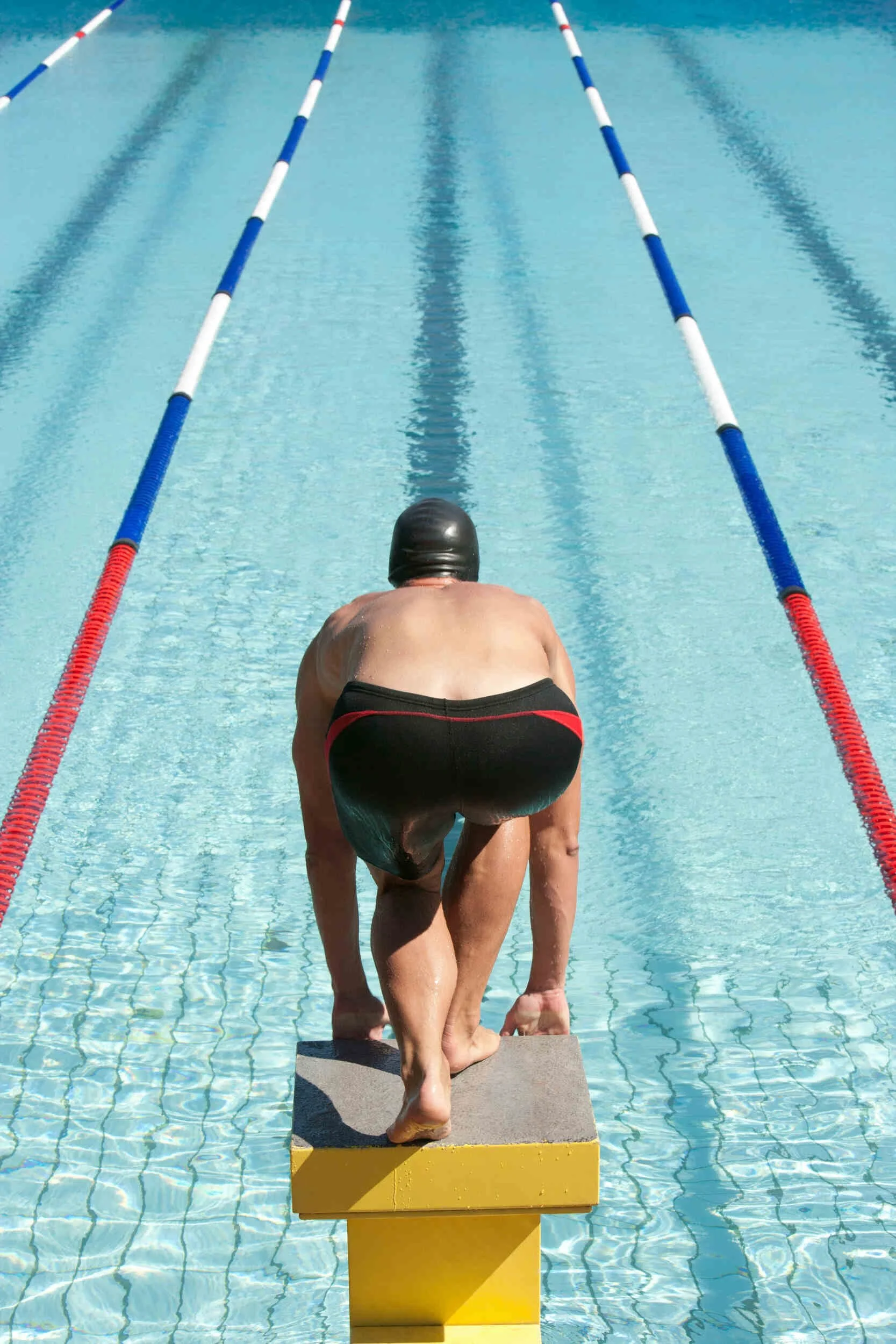 A man swimming jumping off a board into the pool - career change without starting over