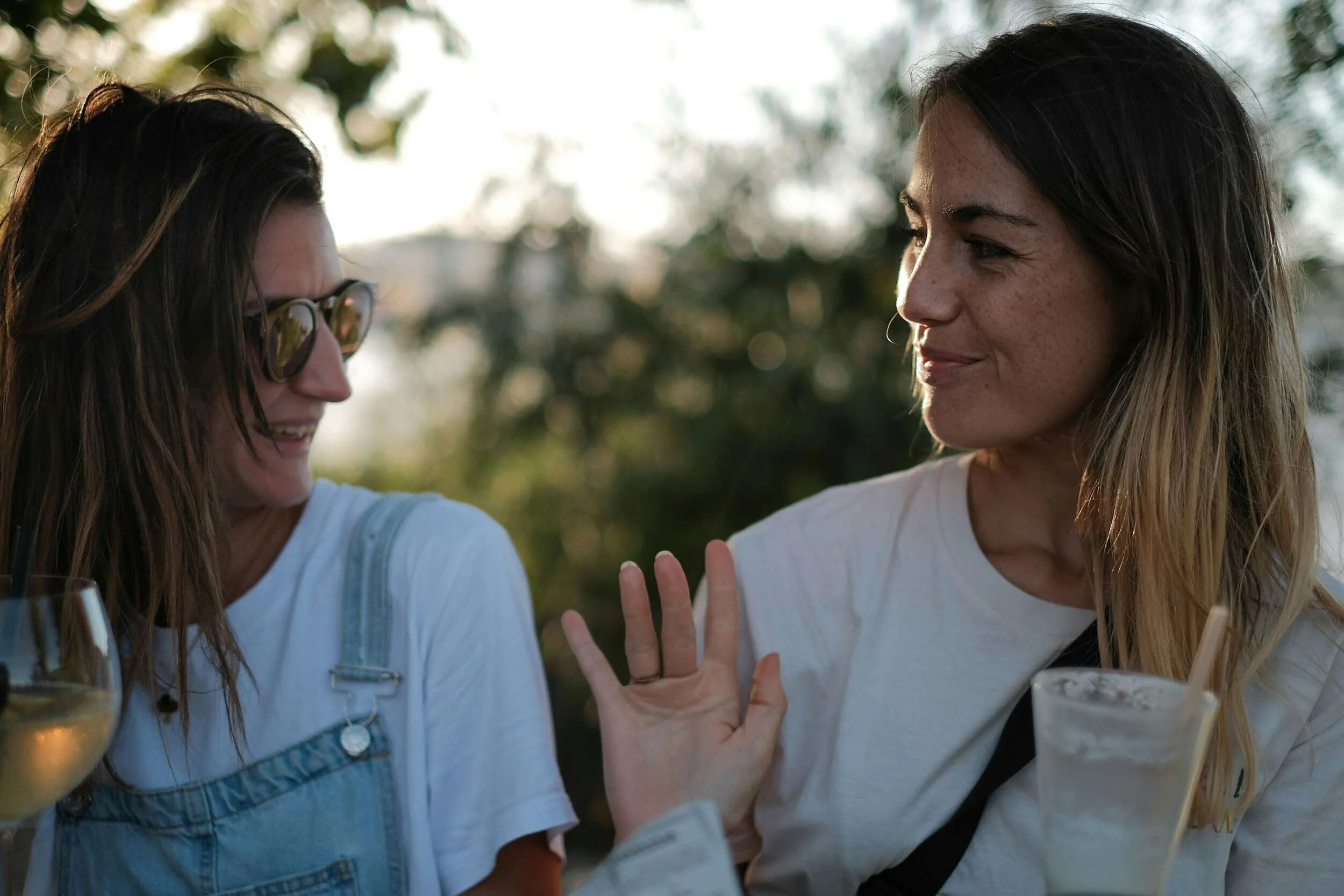 Two women outside smiling and making a connection - career advice Phoenix