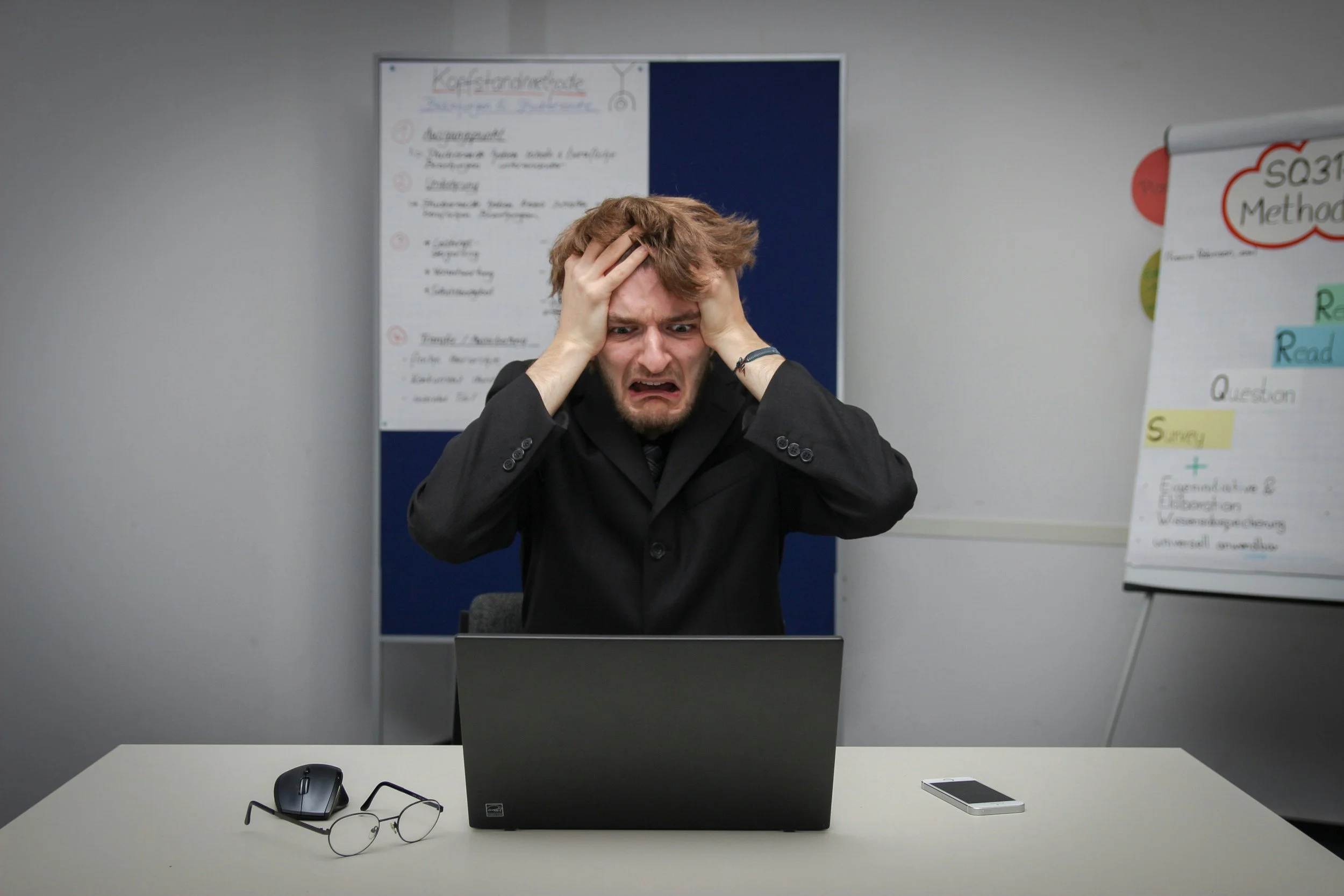 A man with red hair putting his hands on his head in frustration - career transition coach