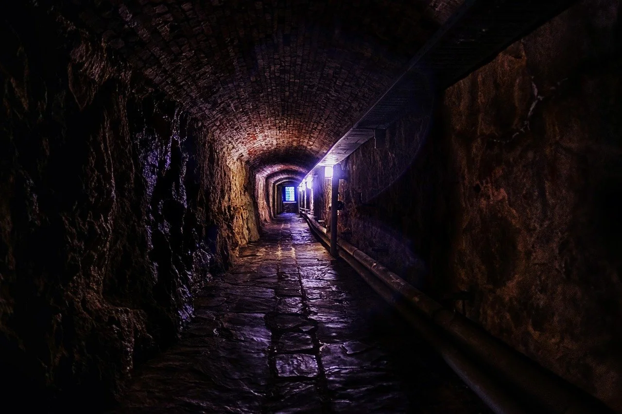 Dark scary tunnel with light at the end of it - career transition coaching