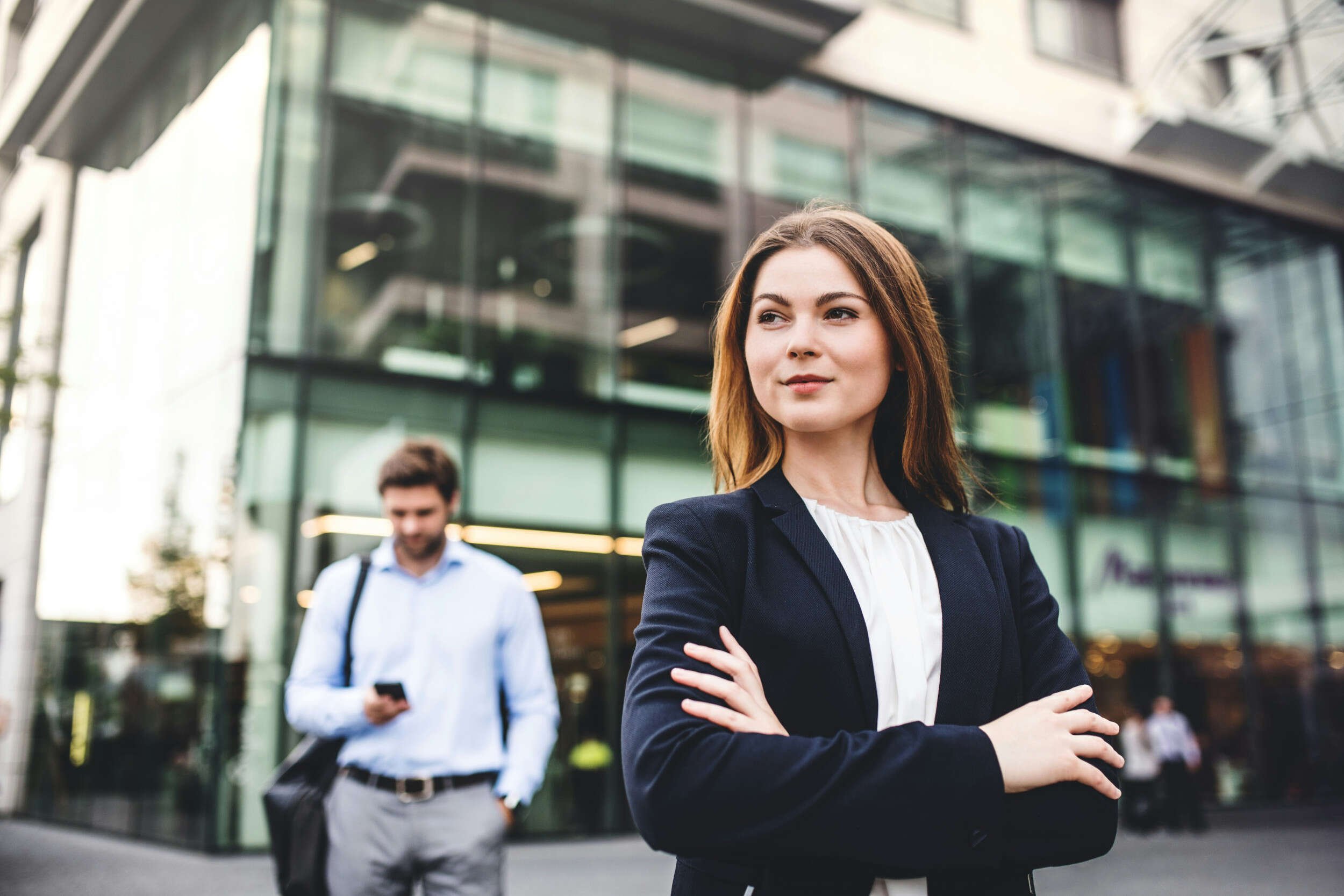 A women in a business suit with her hands crossed outside - mid-career change