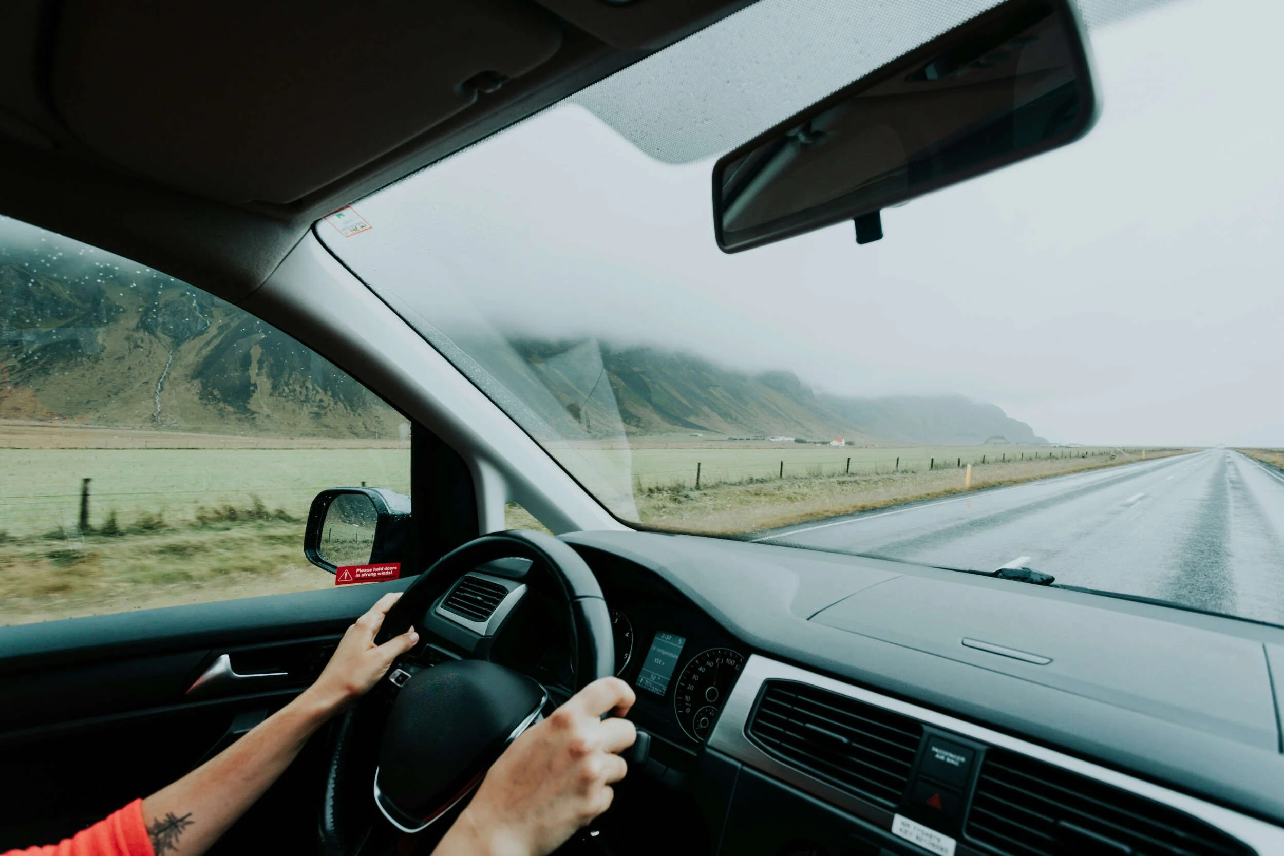 A person driving in a car on a road - test drive a career