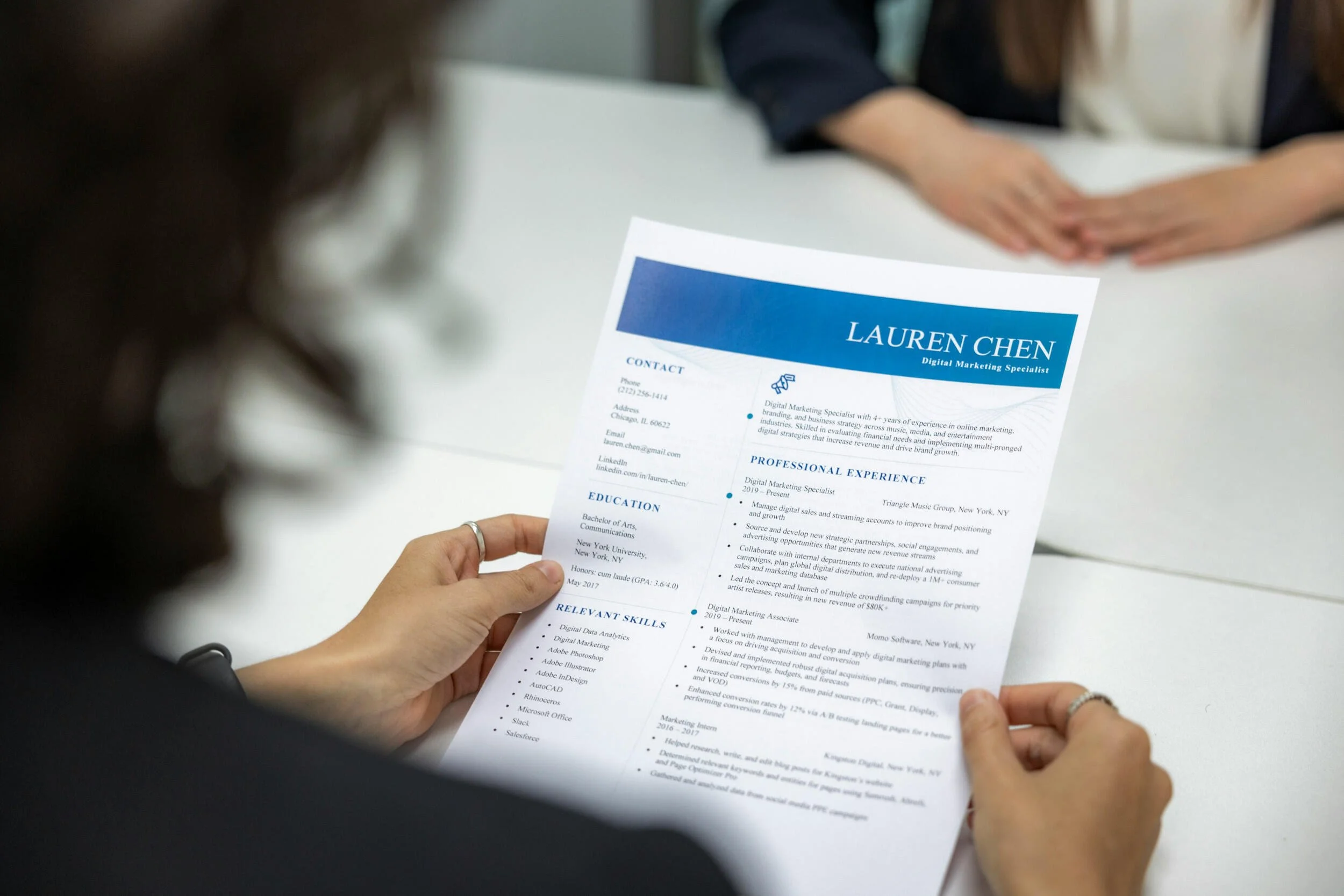 A fancy designed resume in the hands of a women inside - resume help Phoenix