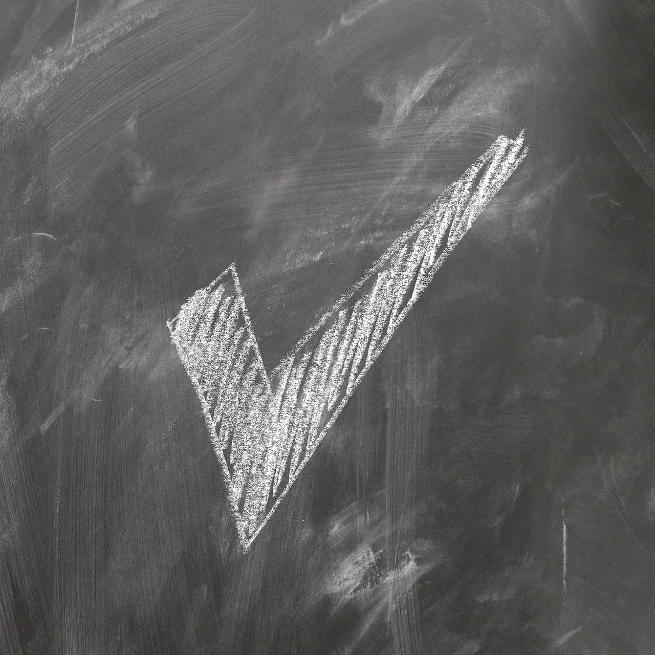 white caulk check mark on the board inside - goal setting after burnout